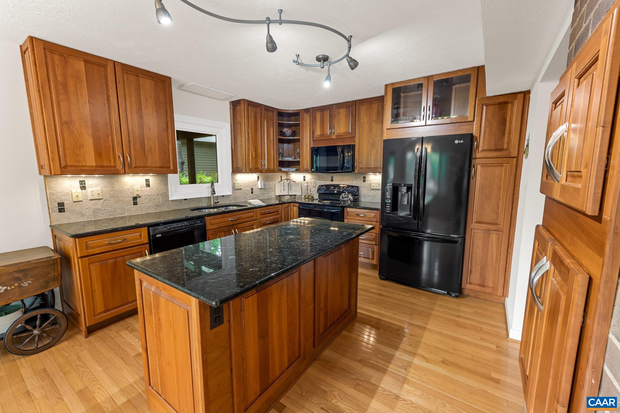 Granite countertops in warm colors and newer appliances complete this gourmet kitchen Granite countertops in warm colors and newer appliances complete this gourmet kitchen