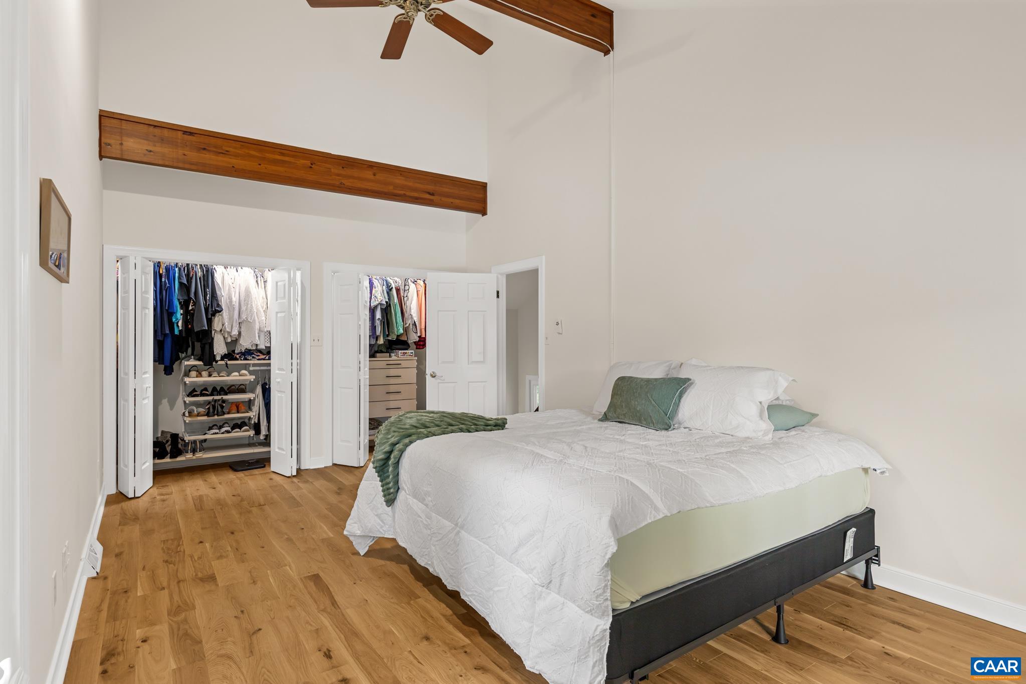 Spacious 2nd floor bedroom featuring incredible water views and ample room to comfortably accommodate 2 king size beds. Vaulted ceilings and double closets Spacious 2nd floor bedroom featuring incredible water views and ample room to comfortably accommodate 2 king size beds. Vaulted ceilings and double closets