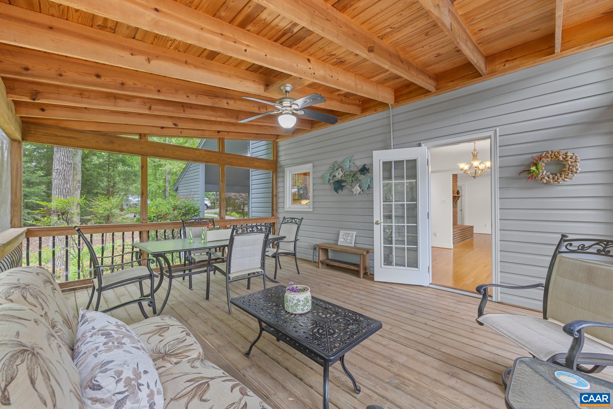 Attached screen room just off the kitchen offers water views and flows directly to the spacious deck for seamless indoor-outdoor living. Attached screen room just off the kitchen offers water views and flows directly to the spacious deck for seamless indoor-outdoor living.