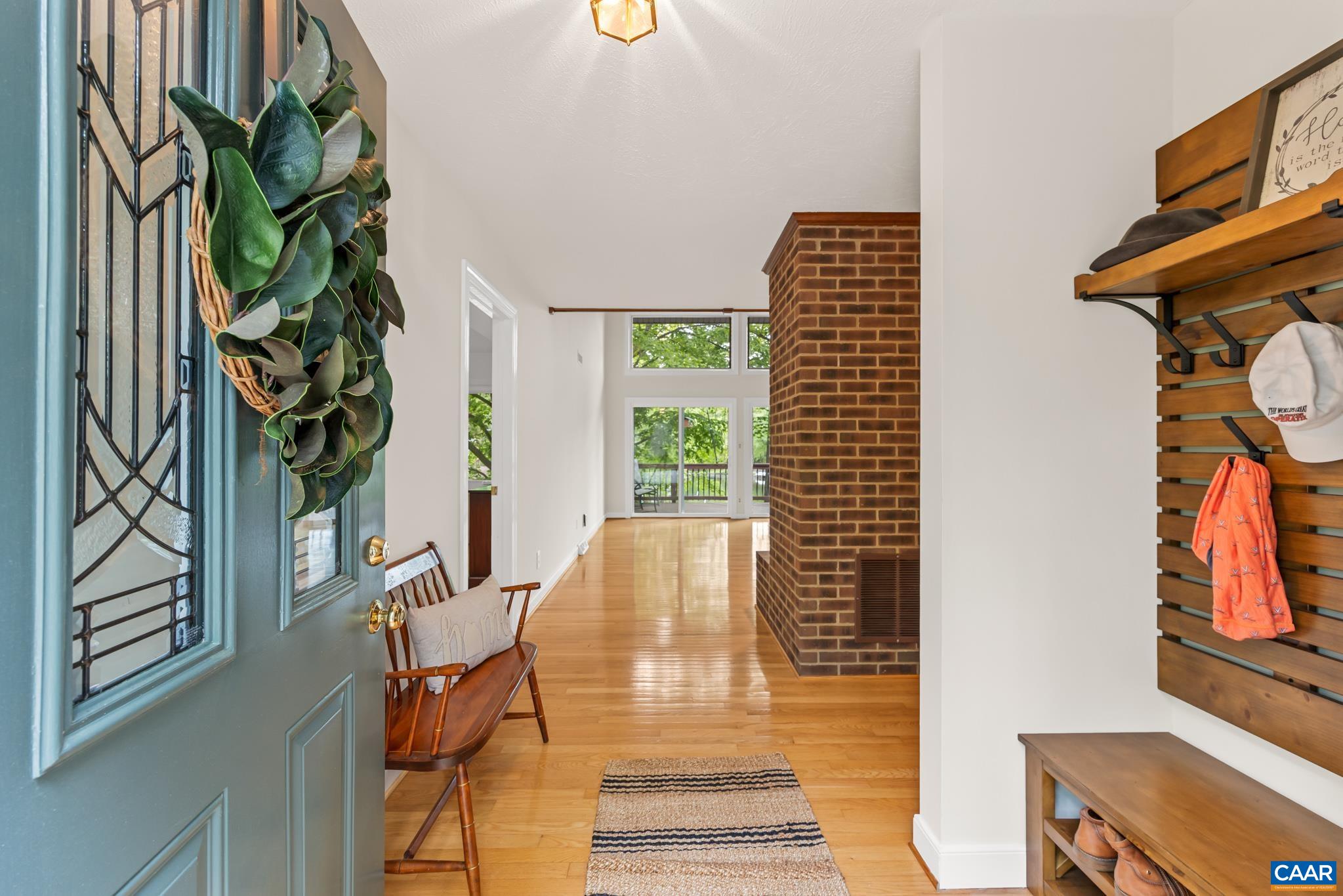Inviting front Foyer opening to vaulted ceilings, open floor plan and gleaming hardwood floors Inviting front Foyer opening to vaulted ceilings, open floor plan and gleaming hardwood floors