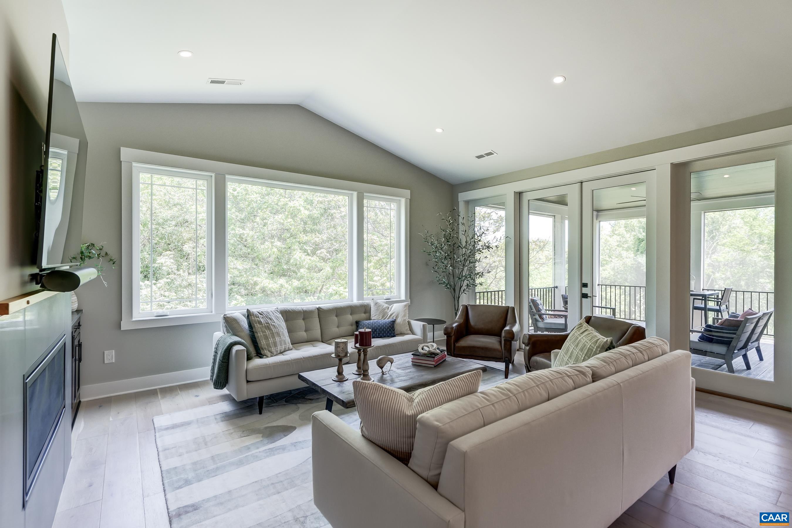 Stunning windows in the great room with French doors leading to the screened porch. Stunning windows in the great room with French doors leading to the screened porch.