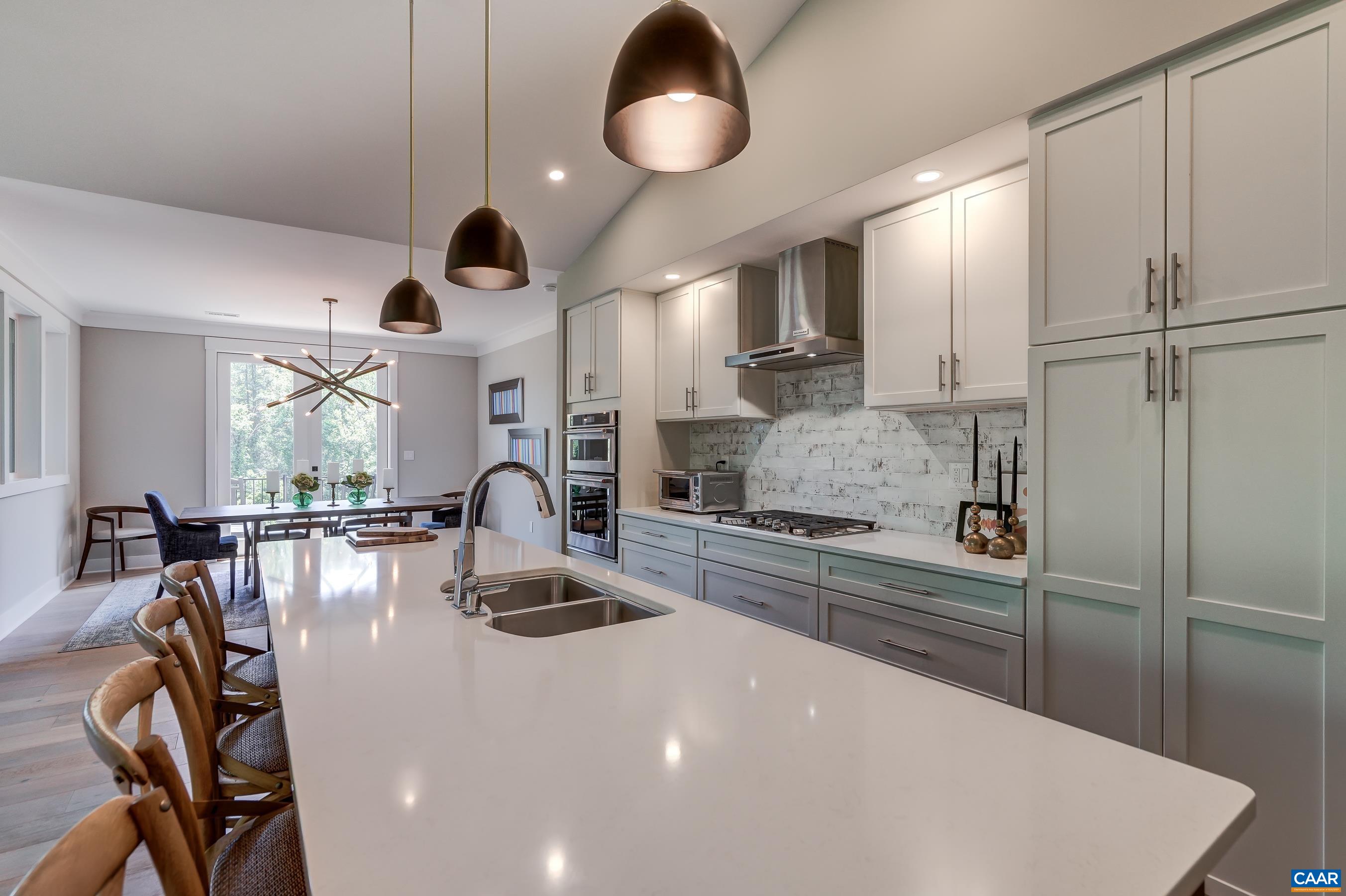 Quartz countertops and pendant lighting over the island. Quartz countertops and pendant lighting over the island.