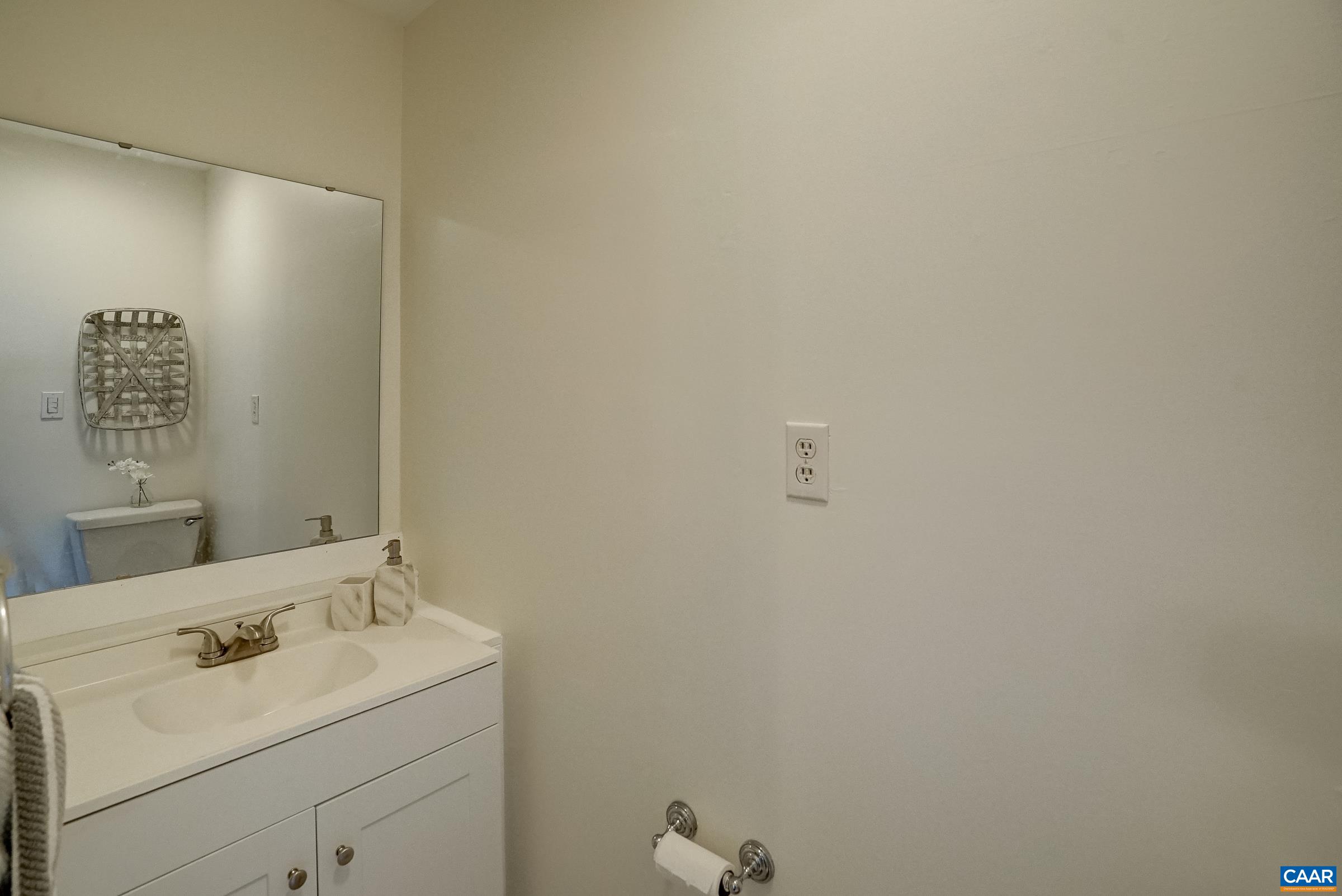 Half bath in primary bedroom offers privacy. Half bath in primary bedroom offers privacy.