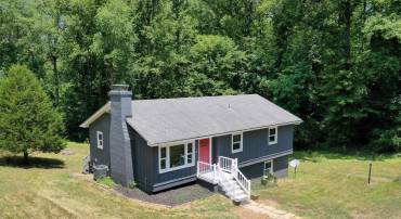Charming home on 2 acres is 10 minutes from Barracks Road, yet feels like country living!