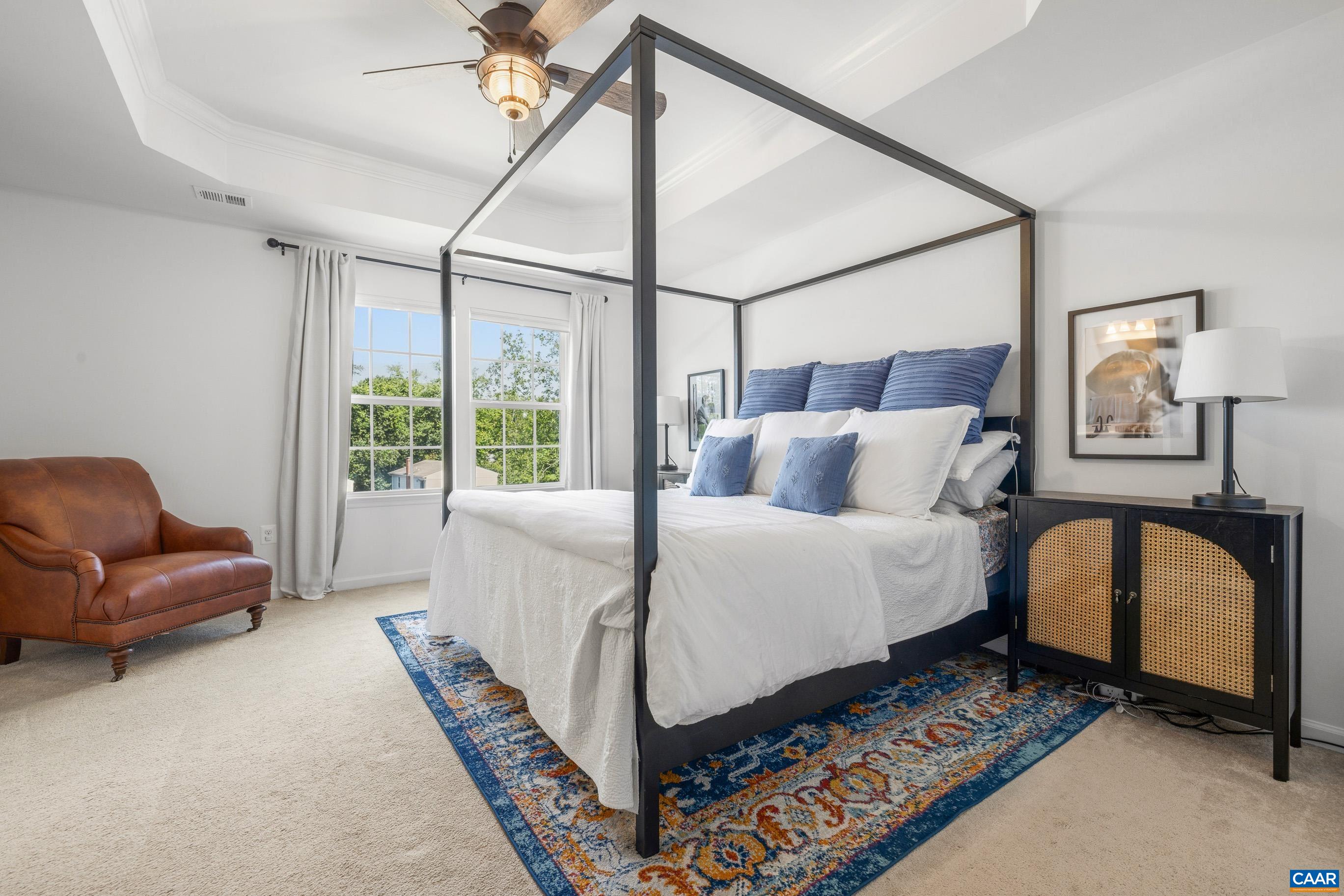 Primary suite with tray ceiling and walk-in closet Primary suite with tray ceiling and walk-in closet