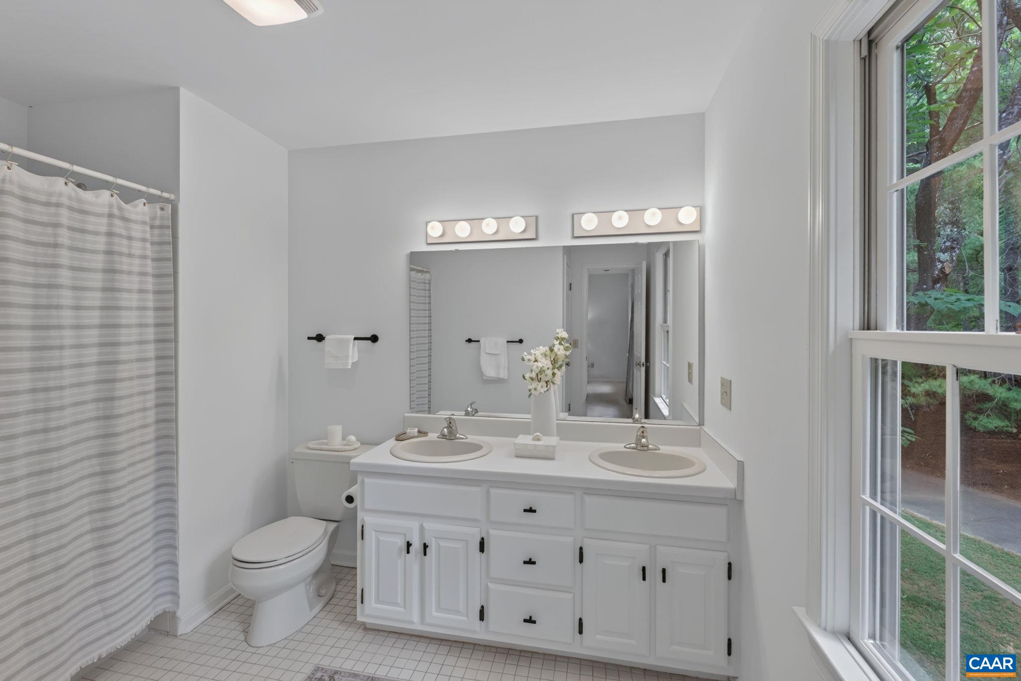 Refreshed en-suite bathroom with tiled shower/tub.