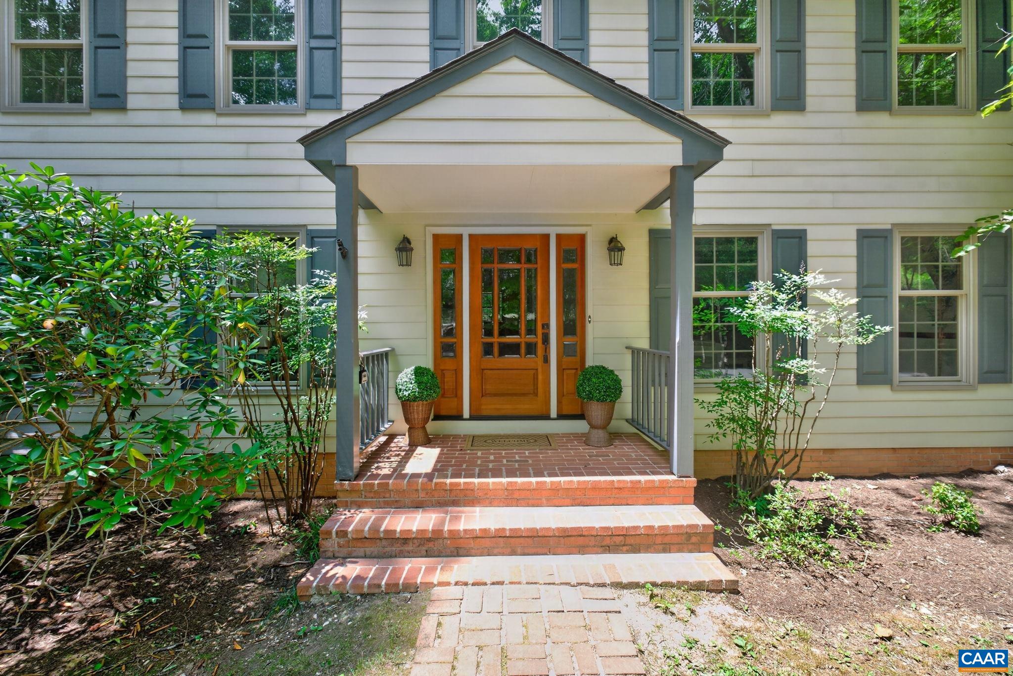 A beautiful mahogany front door welcomes you in.