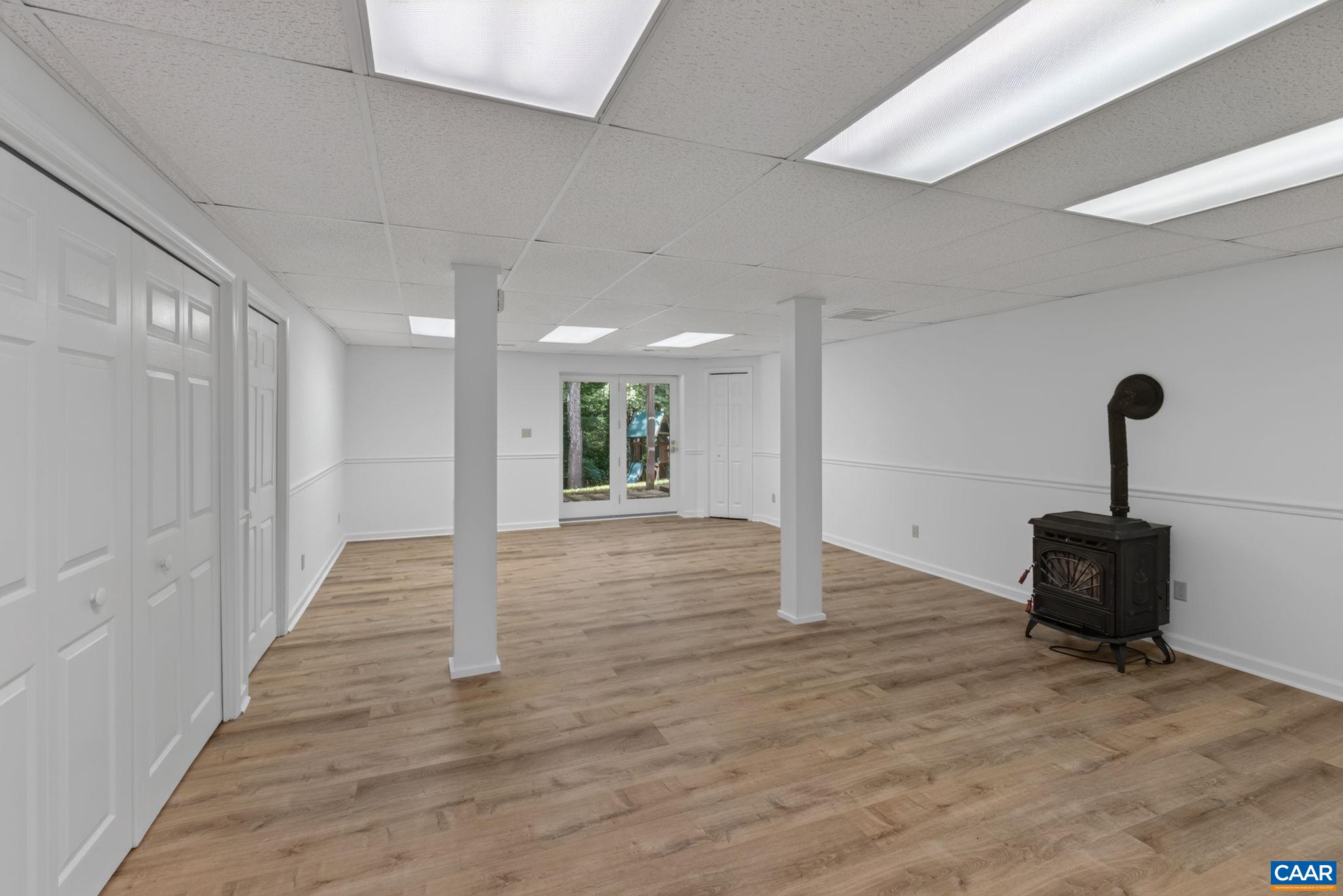 Large rec room in the basement with new flooring and freshly repainted.