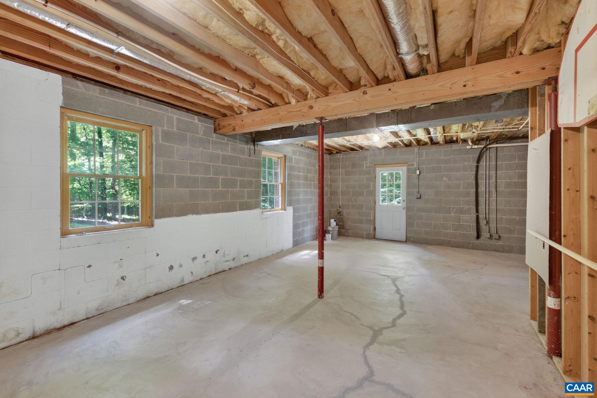 Unfinished storage/utility space in the basement.