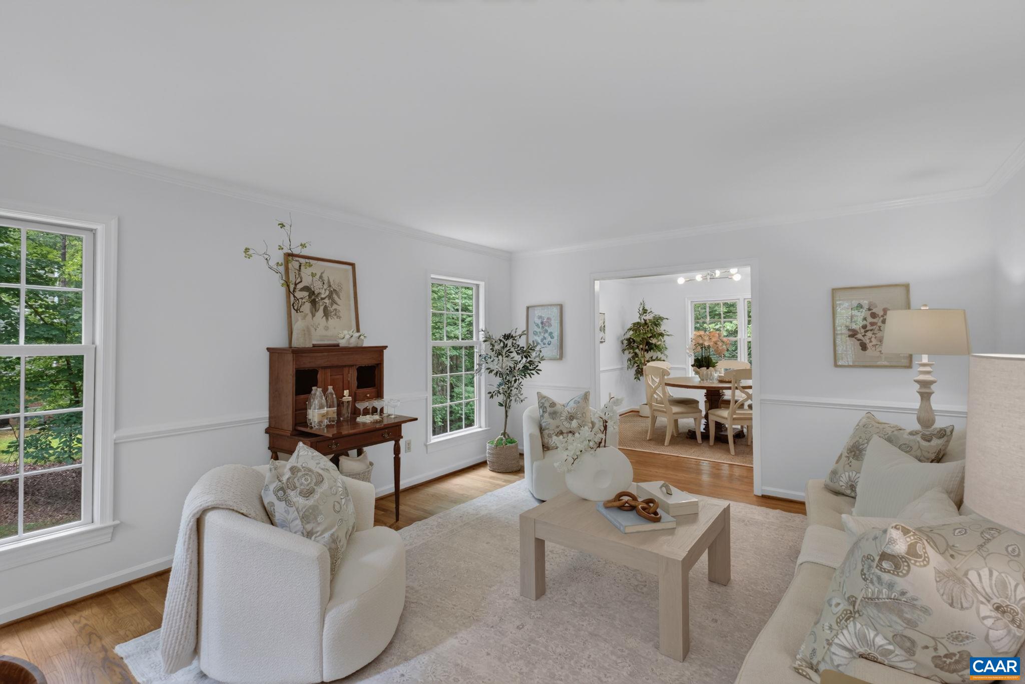 The window-lined living room is an inviting space to relax & entertain.