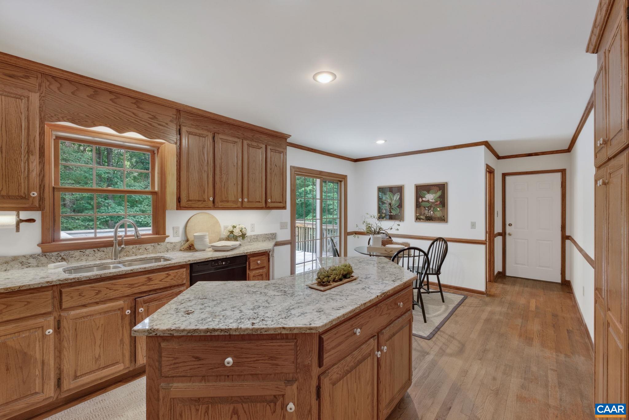 Eat-in-kitchen with large center island and breakfast nook.