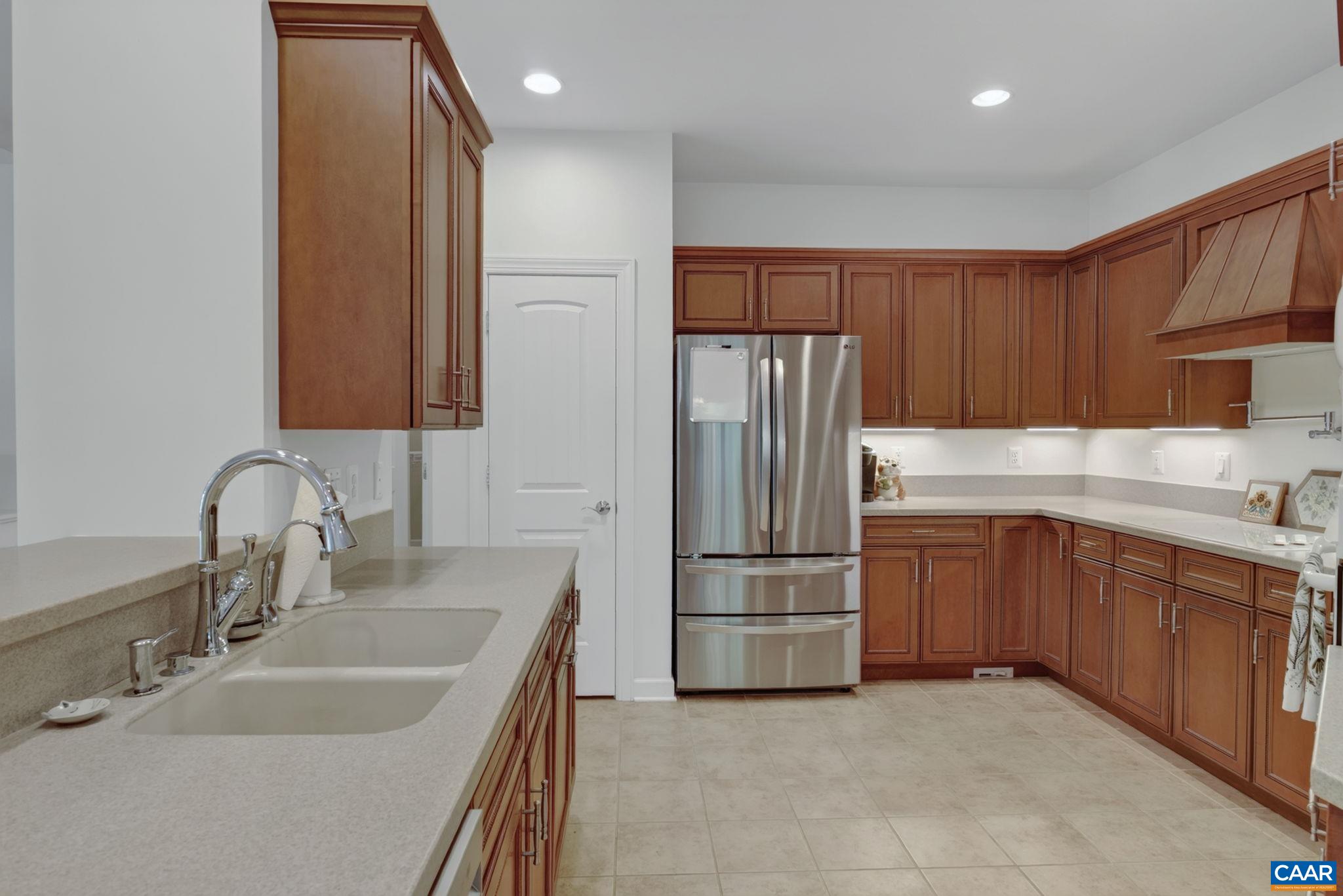 Double kitchen sink overlooks the living room. Lots of counter space and storage.