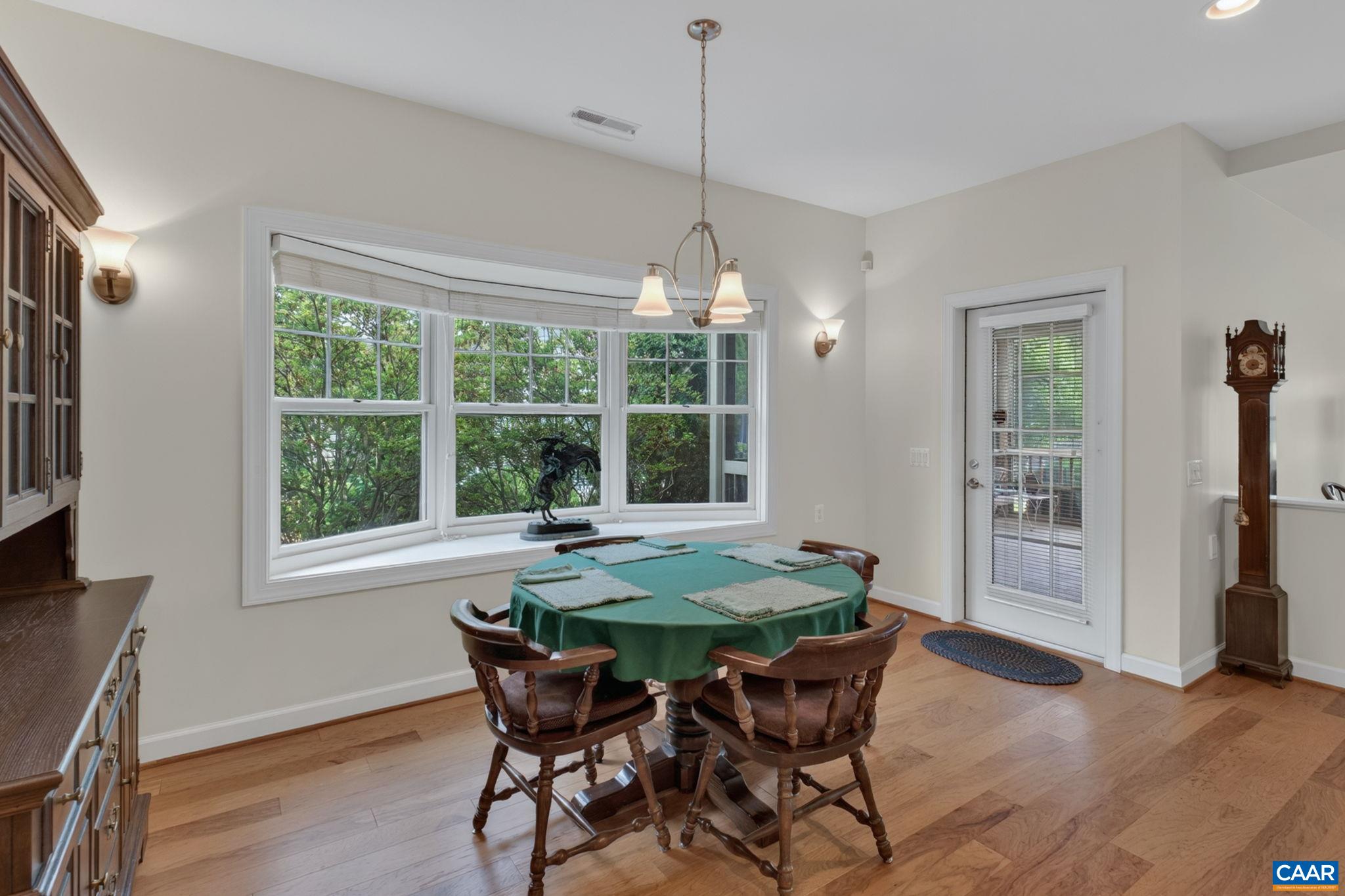 Dining area off kitchen with door to screen porch.