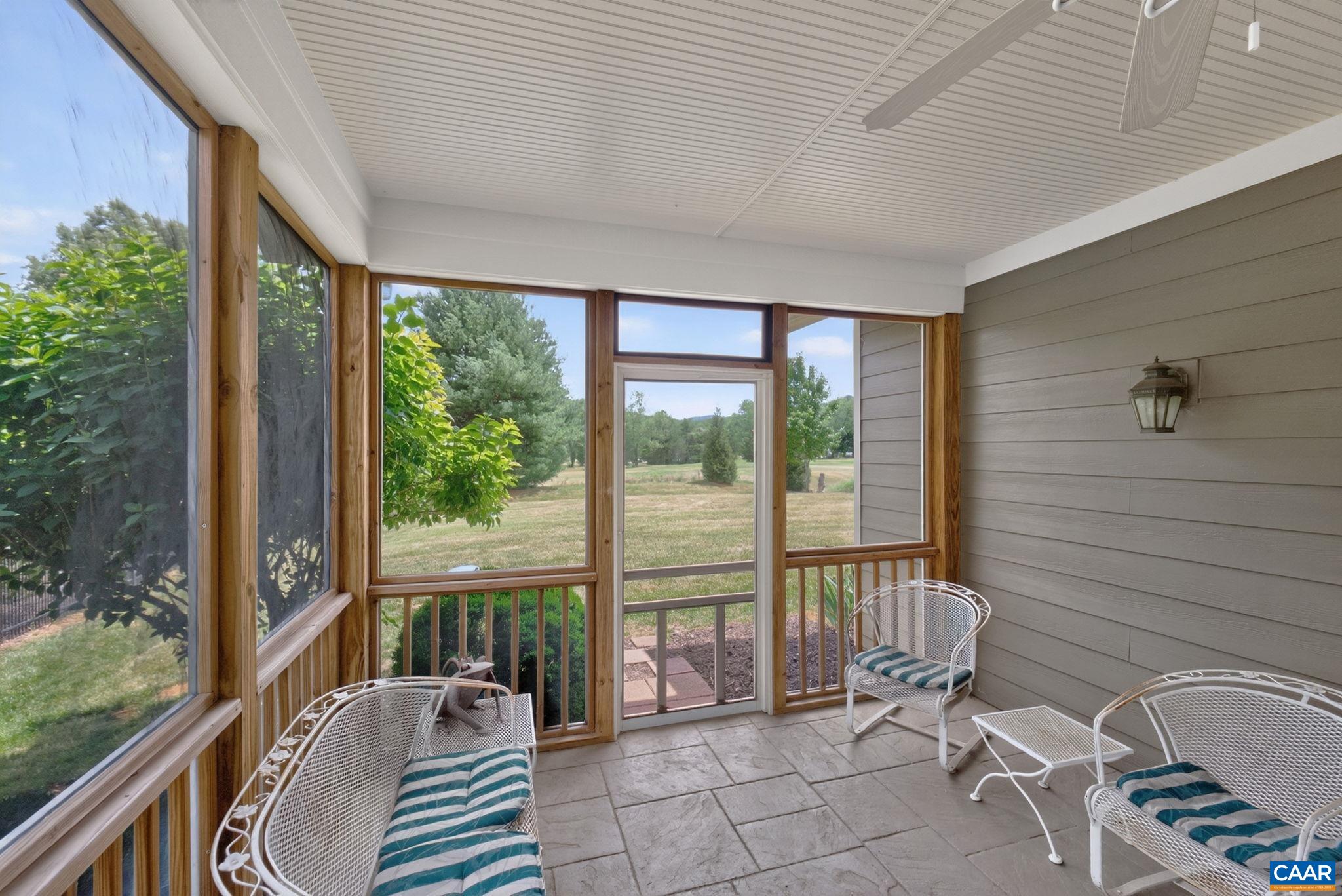 Screen porch with stamped concrete floor.