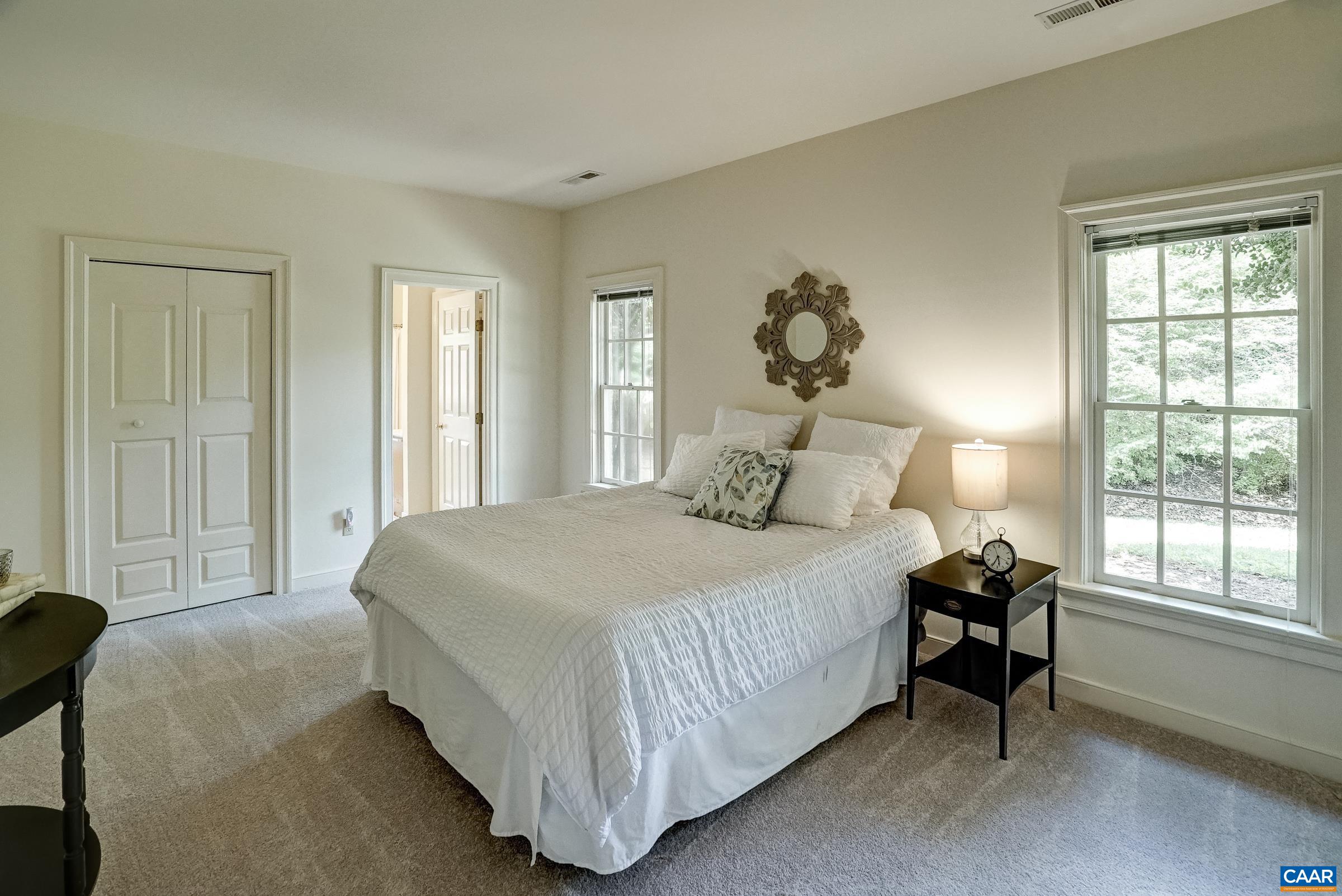 Primary suite features a large walk-in closet with two additional closets and an ensuite bathroom.