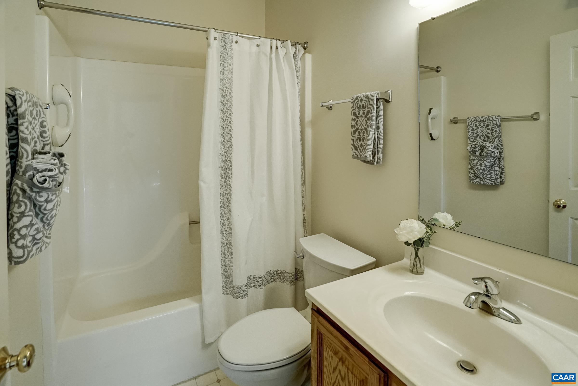 Full hall bathroom with tub/shower combo.
