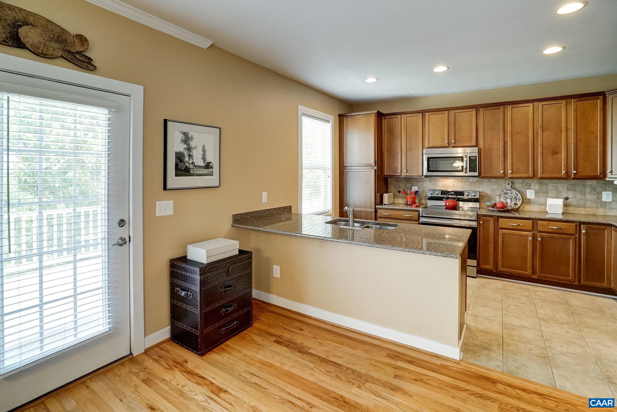 Updated kitchen with maple cabinets, granite counters and stainless appliances.