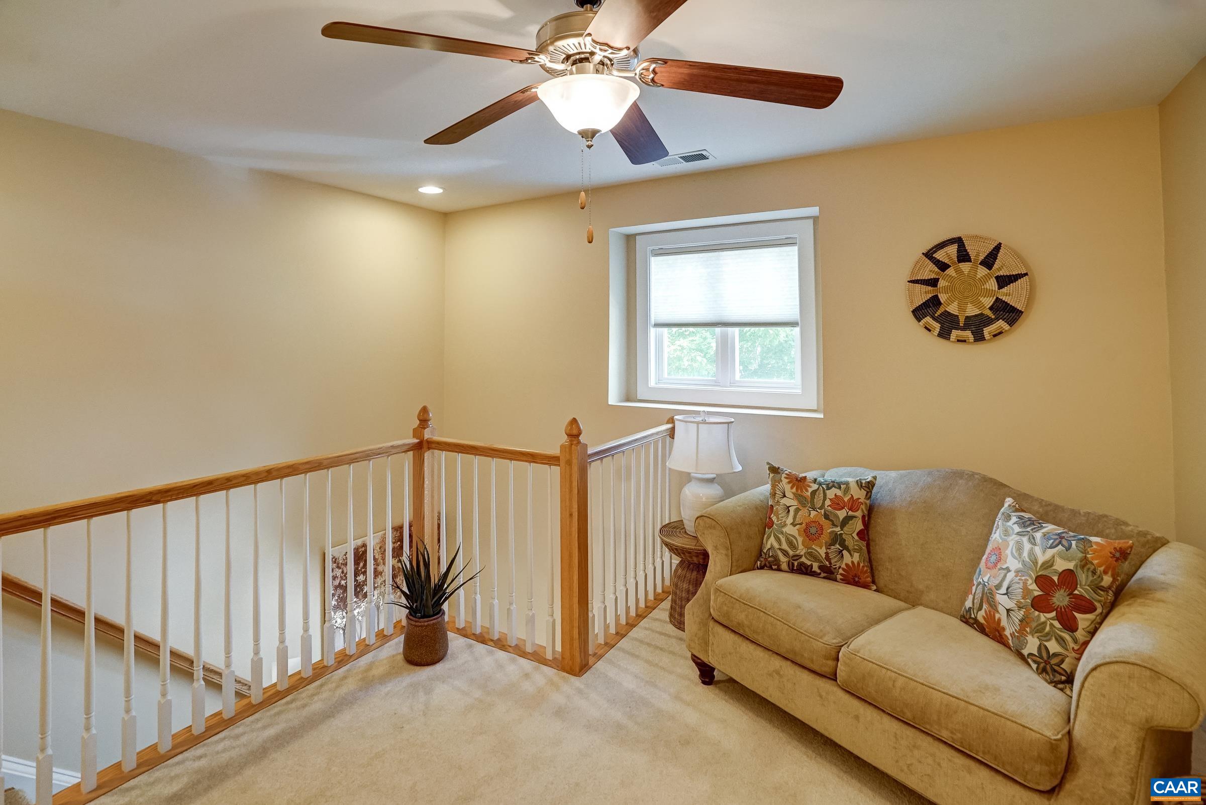 Loft space on the second floor is a cozy reading nook or play area.