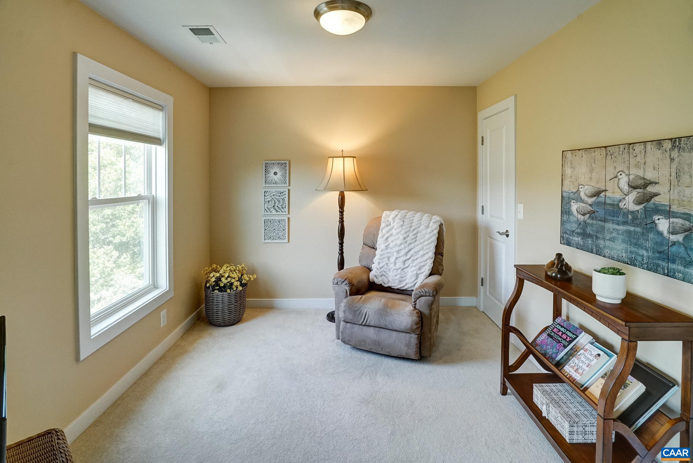 Primary sitting room could also be a nursery or home office space.
