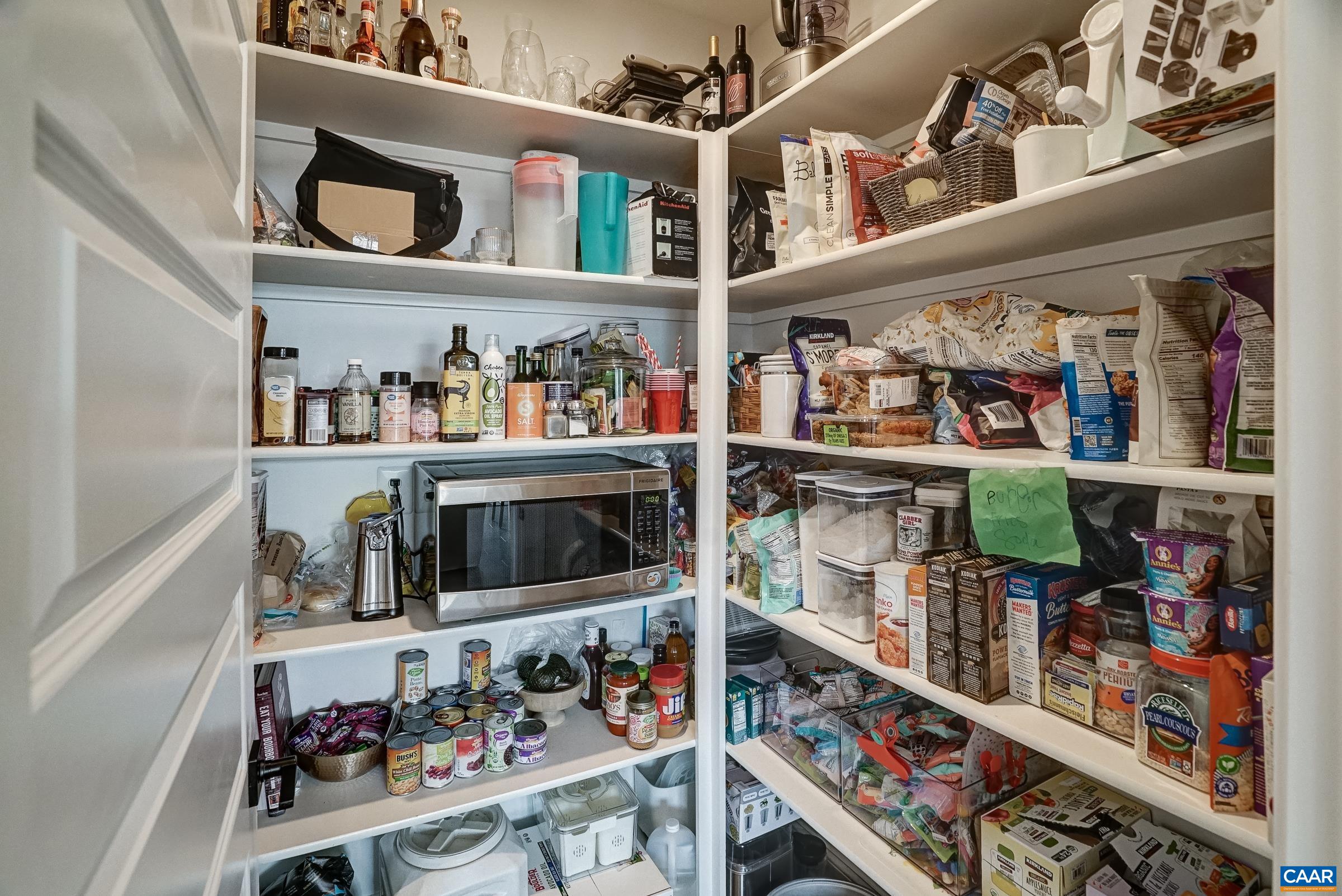 Walk in pantry with solid shelves.