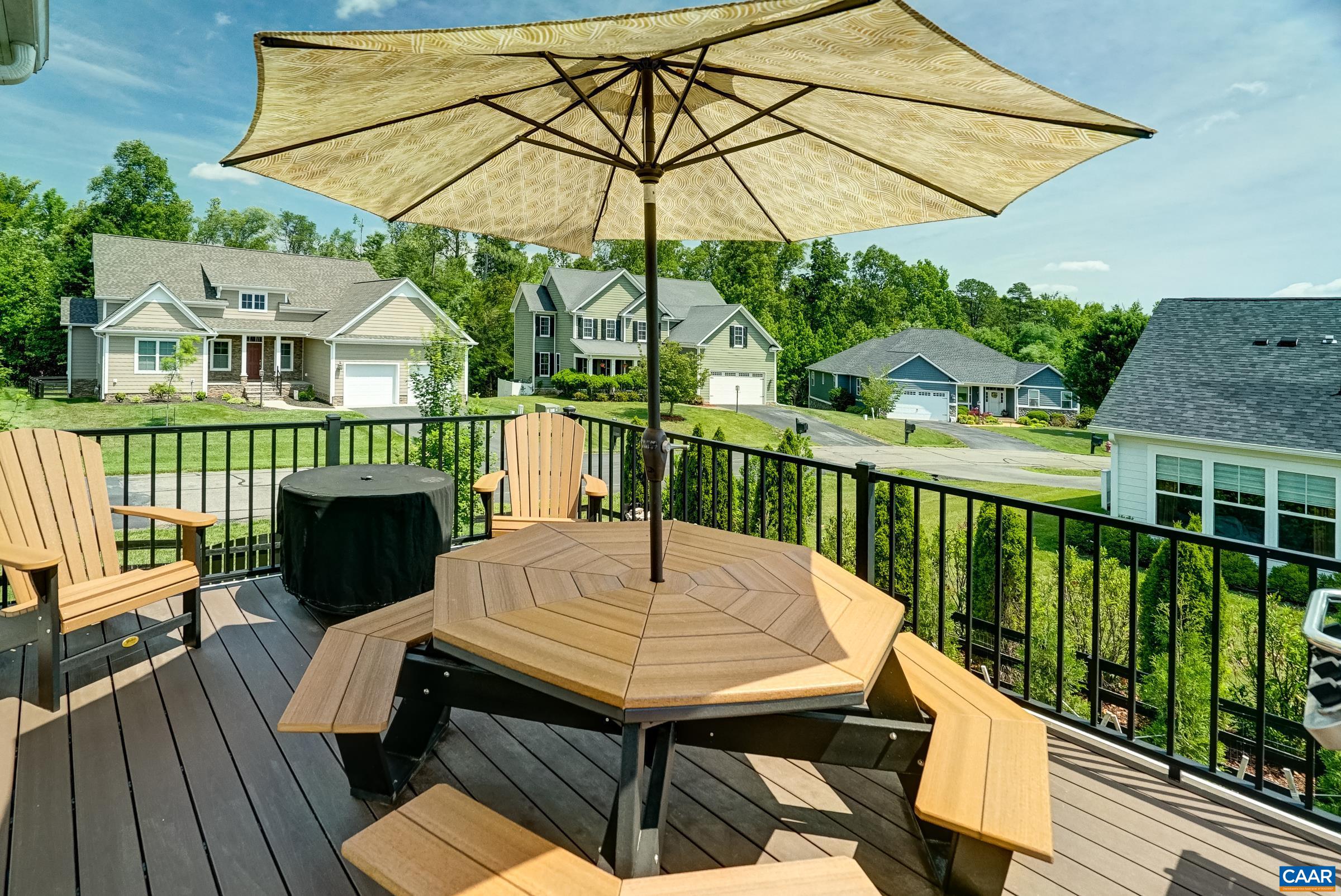 Composite deck overlooking fenced yard.
