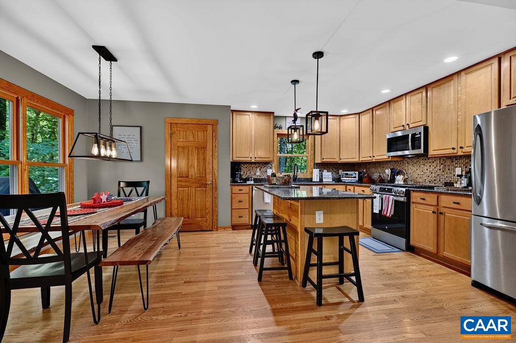 Wonderful open kitchen featuring granite counter tops, maple cabinets, gas range and a pantry.