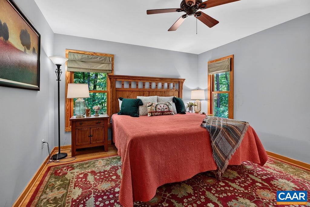 The primary suite is conveniently located on the main level and features a beautifully appointed bathroom and a walk-in closet.