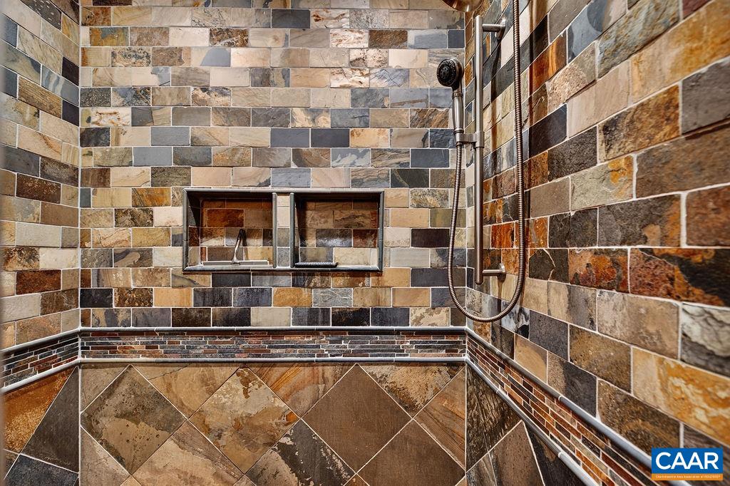 Stunning tiled shower in the primary bathroom.