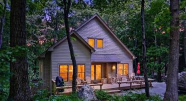 Charming Craftsman-style mountain home tucked away on a peaceful, private wooded lot, surrounded by nature and enhanced by stunning rock formations that add to the property's majestic setting.