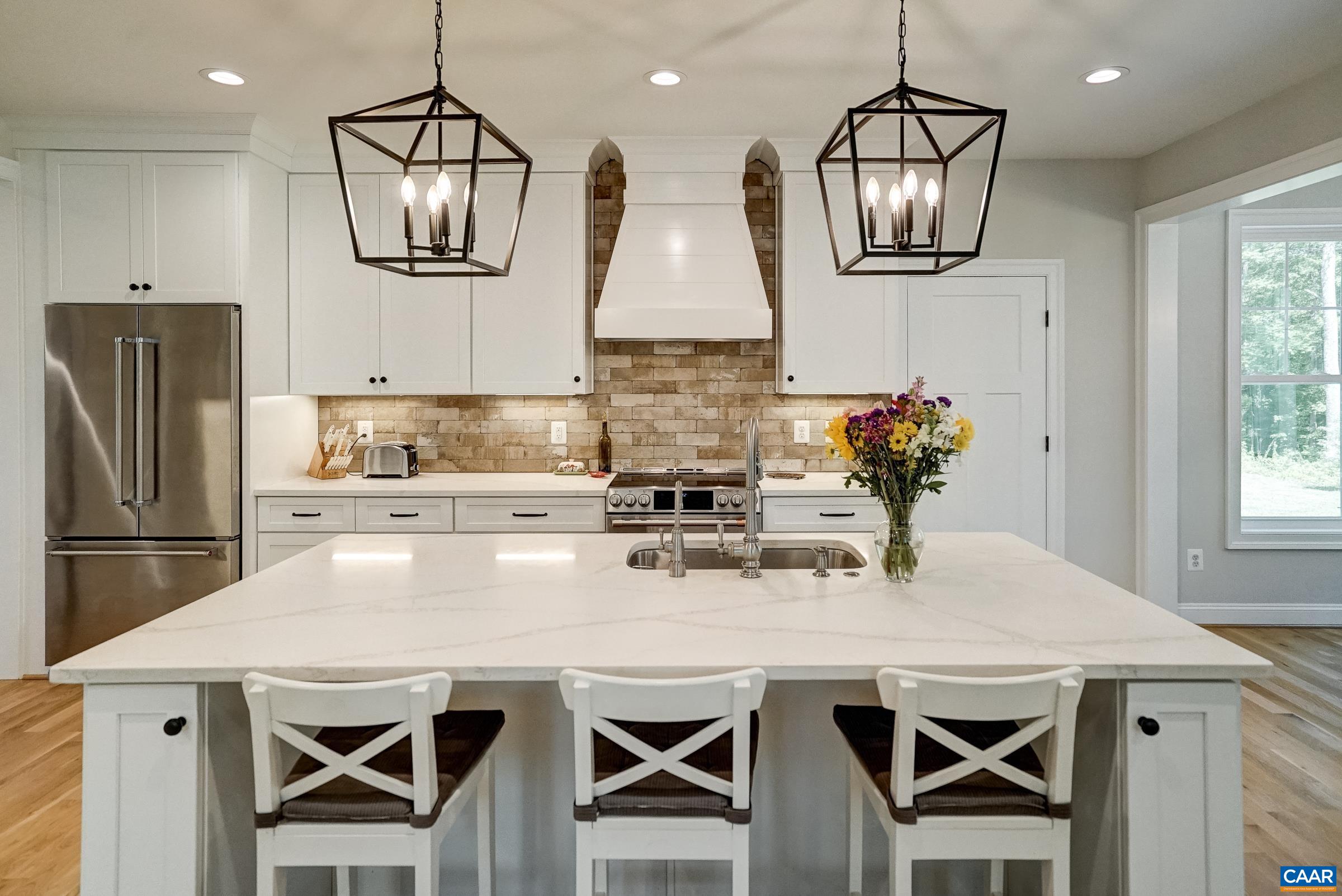 Seating space at the island with beautiful pendant lights.