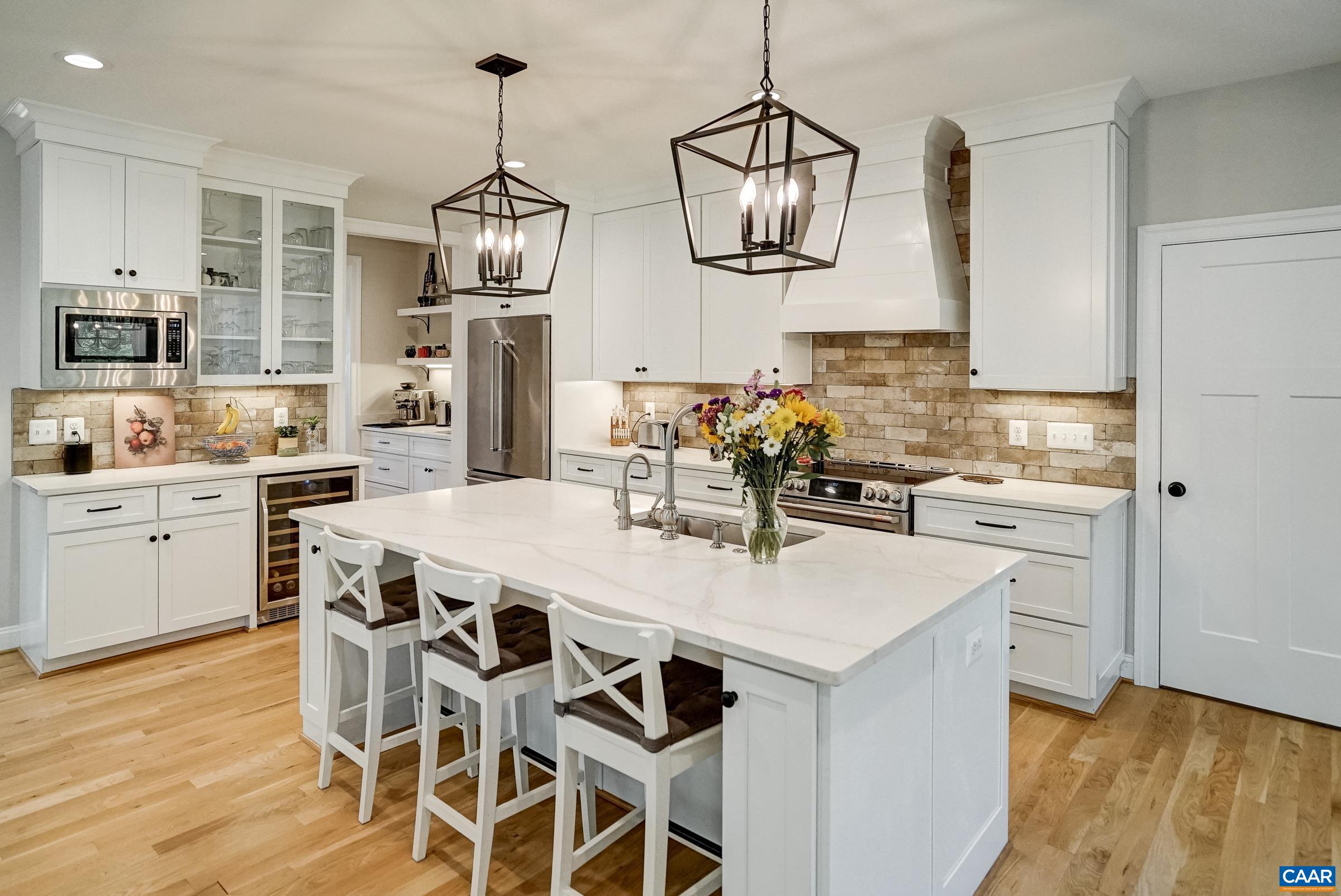 Wine cooler, induction cooktop, and stainless appliances.