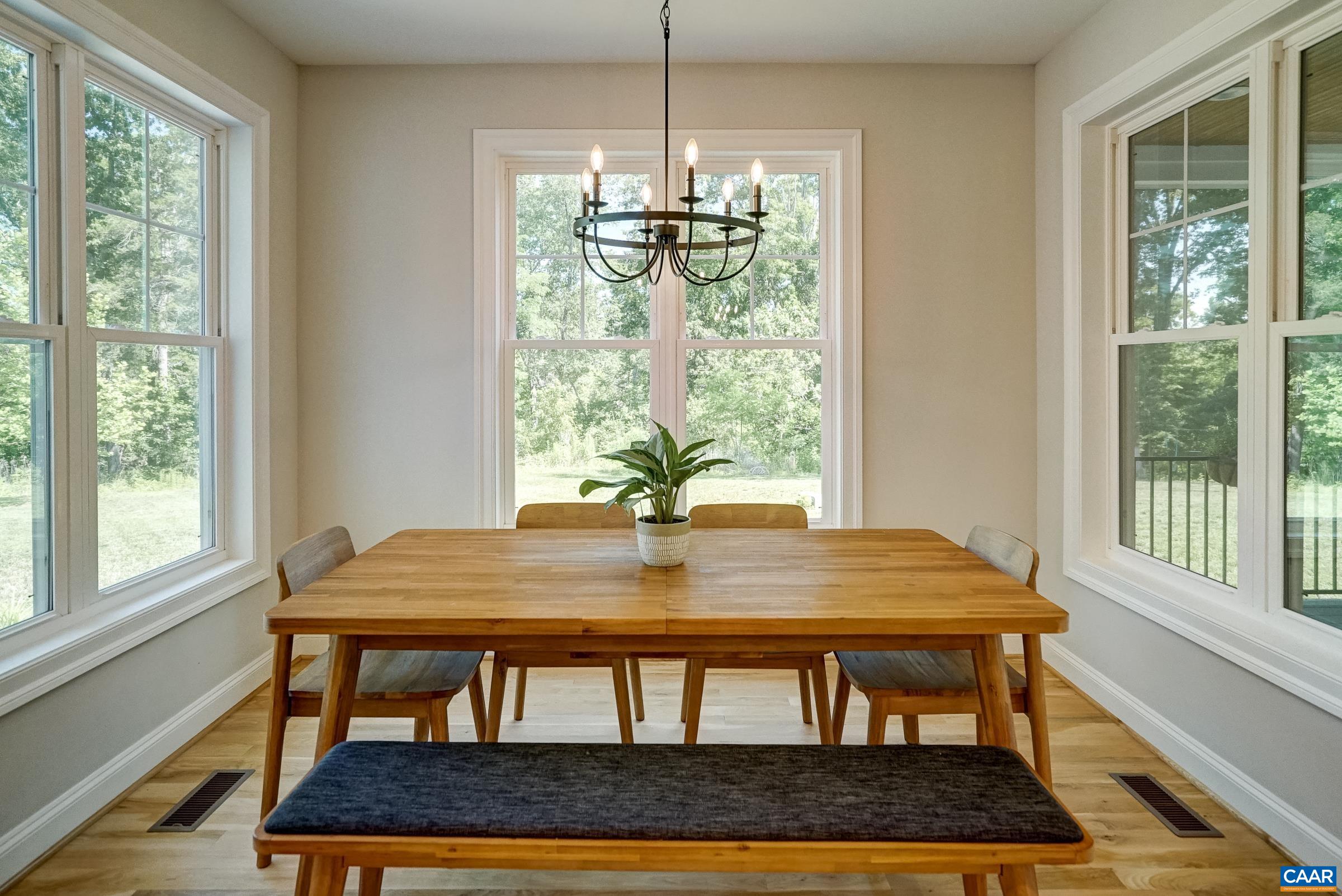 Light filled breakfast room with three walls of windows.