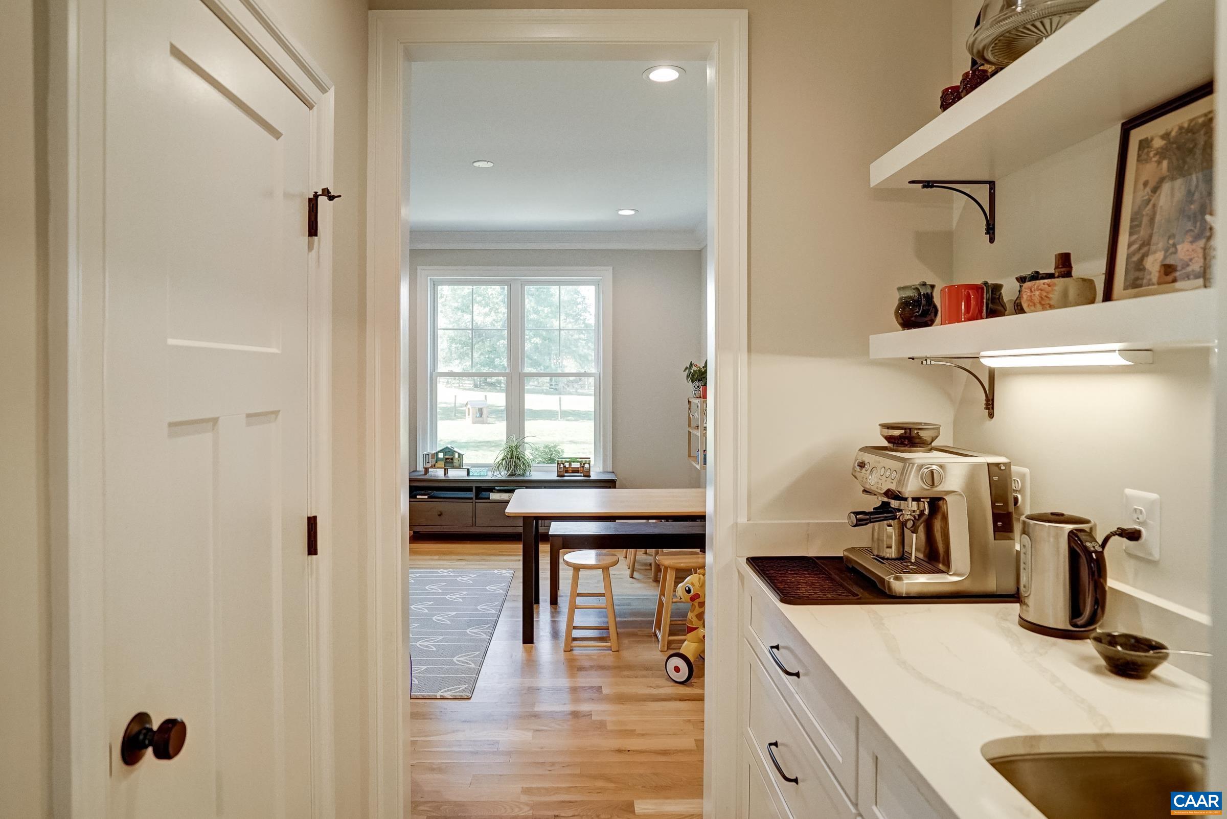 Butlers pantry with wet bar and large walk-in pantry.