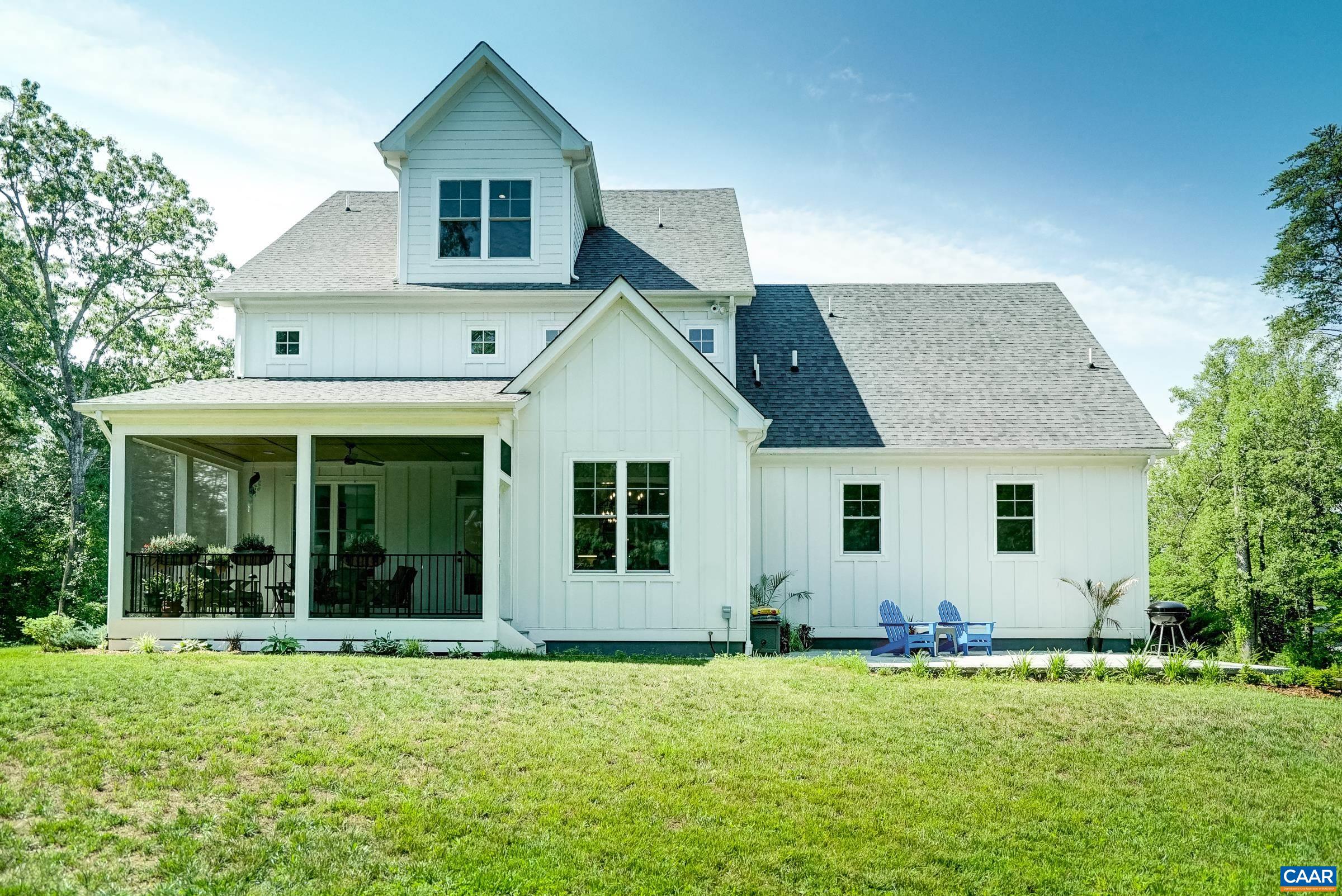 Screened porch and paver patio overlooking the private, flat back yard.