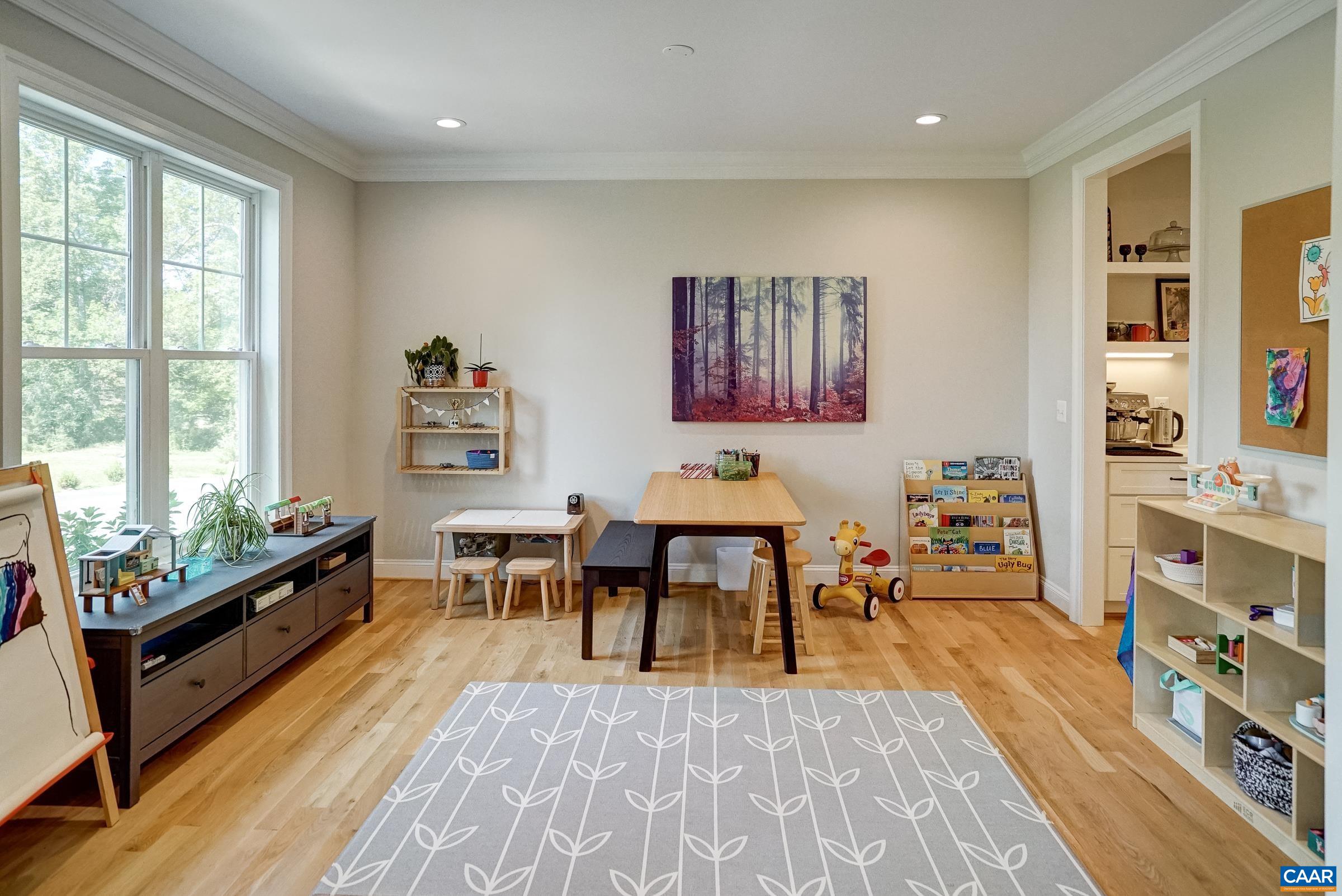 To the Left of the foyer is a flexible room that could be a dining room or play room.
