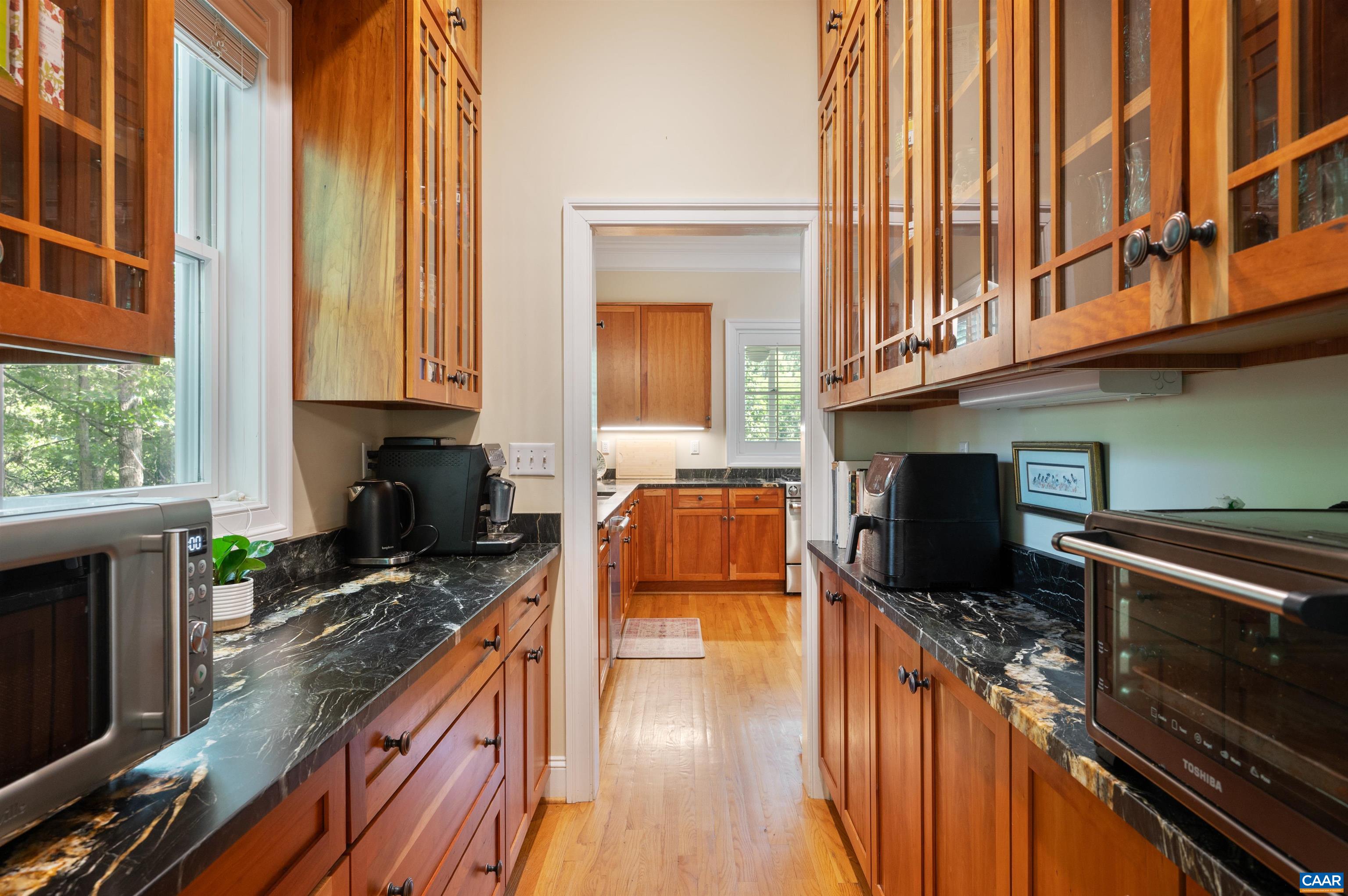 Glass front cabinets and a window are so beautiful