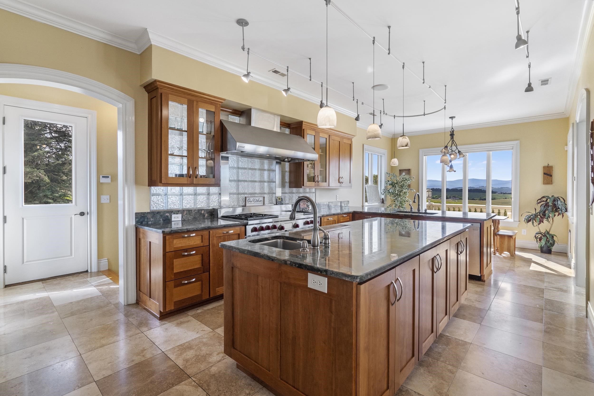 This dream kitchen was designed by a chef, the owner. Very deep island with prep sink, and the counters are like non you will see many places. Look close and it looks like water over stones in a river, a feature that brings nature into the home This dream kitchen was designed by a chef, the owner. Very deep island with prep sink, and the counters are like non you will see many places. Look close and it looks like water over stones in a river, a feature that brings nature into the home