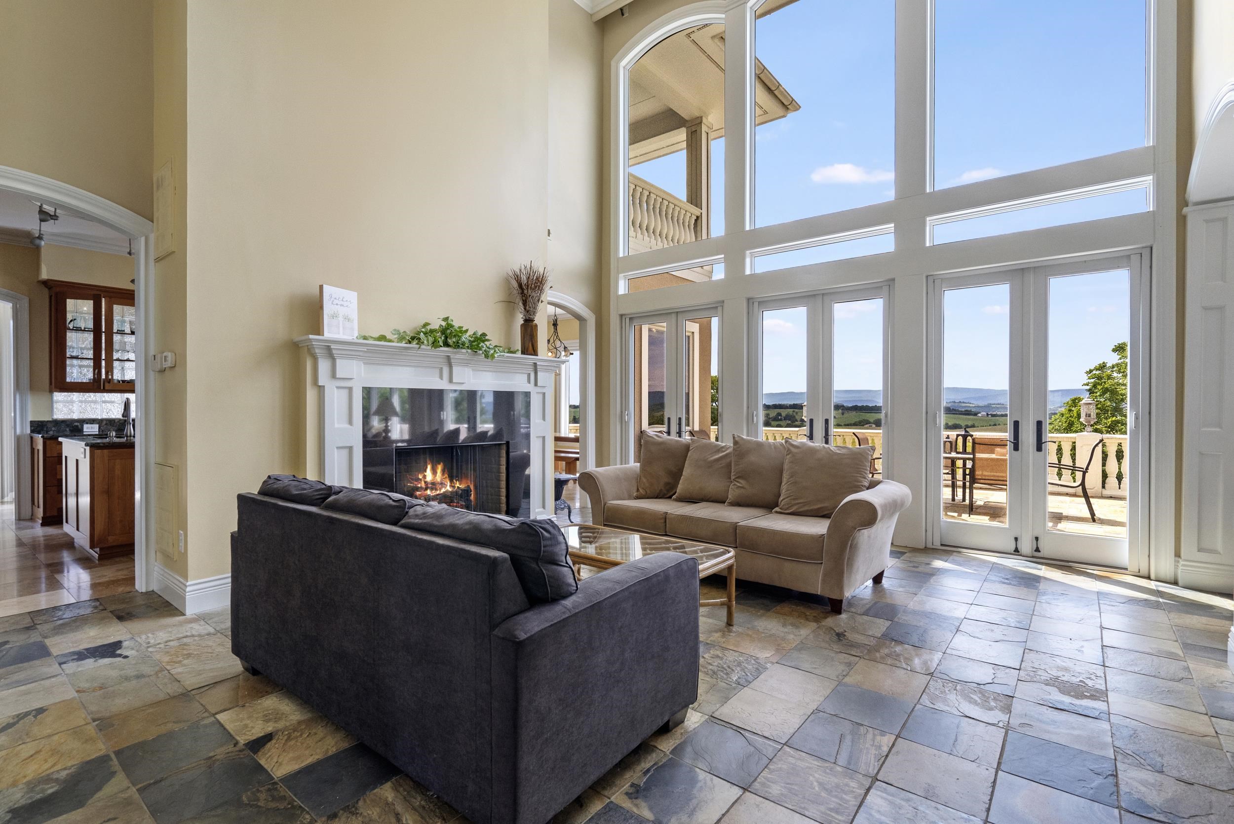 Surround sound system in lower level of home as well as Primary Bedroom and Bath. The over 5' gas fireplace grounds the room giving the warm element tied in with Travertine floors, soaring glass windows and magnificent views. Surround sound system in lower level of home as well as Primary Bedroom and Bath. The over 5' gas fireplace grounds the room giving the warm element tied in with Travertine floors, soaring glass windows and magnificent views.