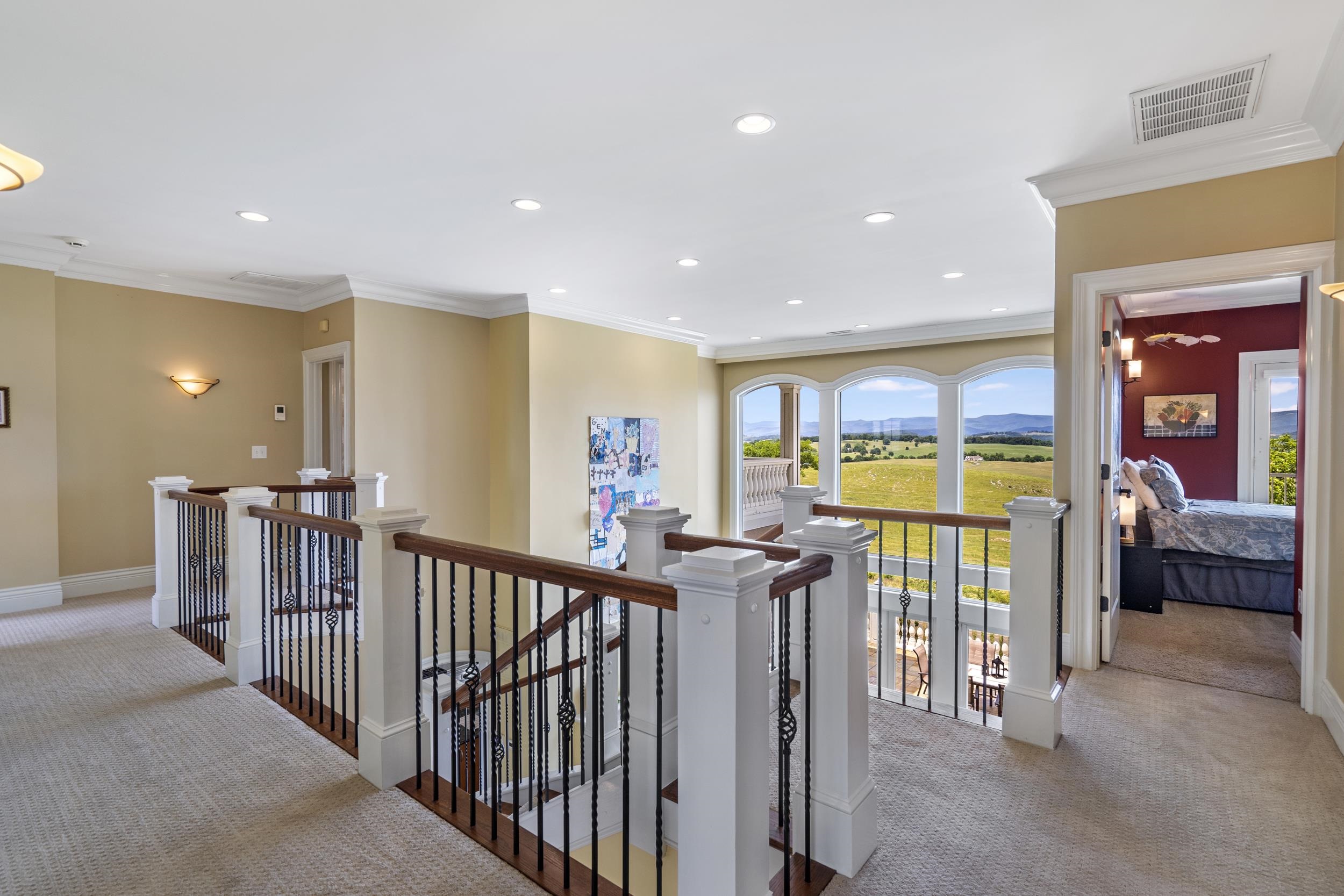 The winding staircase takes you to this landing where the views continue. The galley hallway leads to all four bedrooms and baths The winding staircase takes you to this landing where the views continue. The galley hallway leads to all four bedrooms and baths