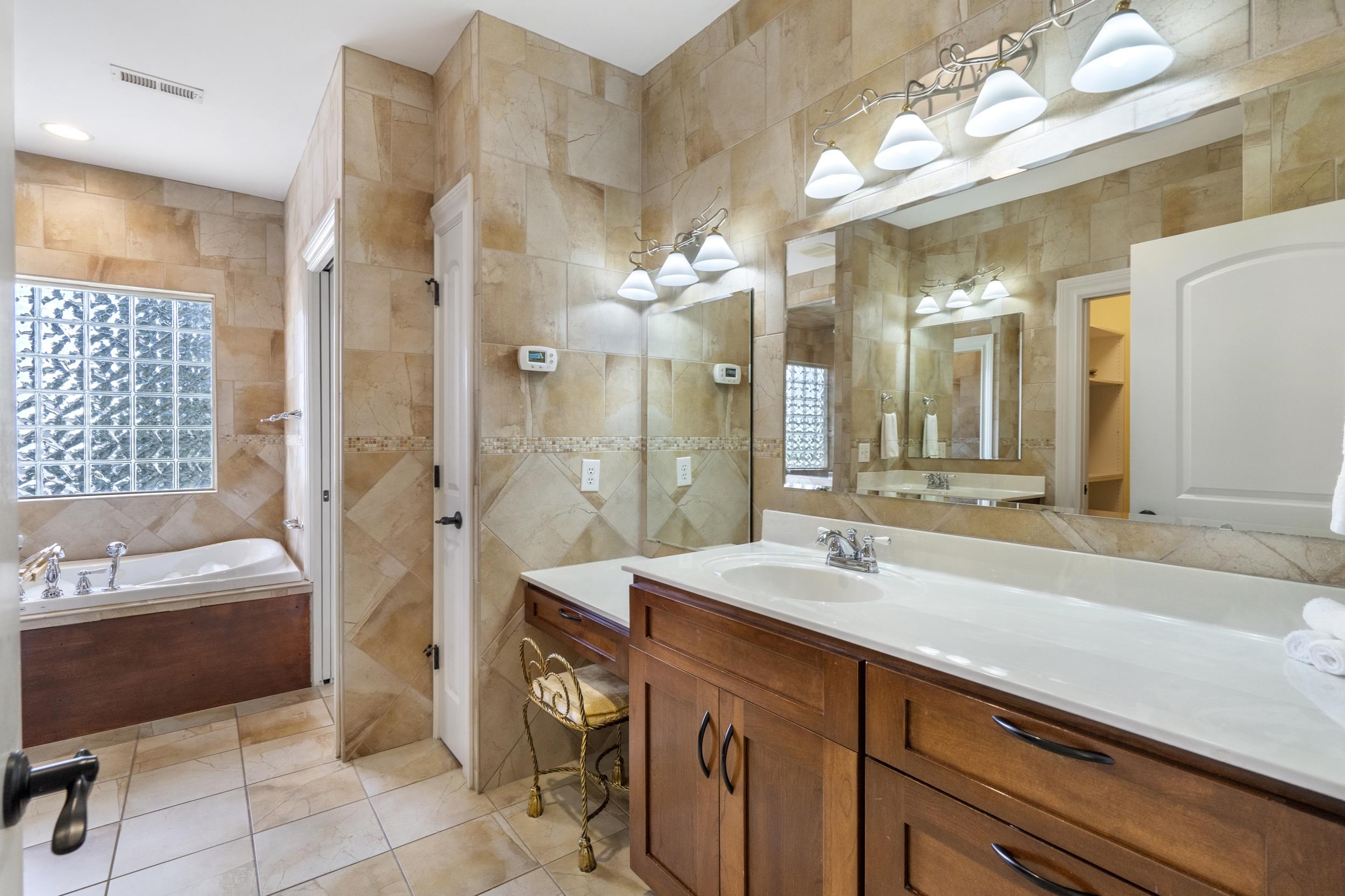 This Primary bathroom screams RELAXATION. The shower is also a steam shower with two fold down stools, jetted tub to relax, block glass for the window offering privacy and natural light, two sinks and a dedicated vanity along with large closet. This Primary bathroom screams RELAXATION. The shower is also a steam shower with two fold down stools, jetted tub to relax, block glass for the window offering privacy and natural light, two sinks and a dedicated vanity along with large closet.