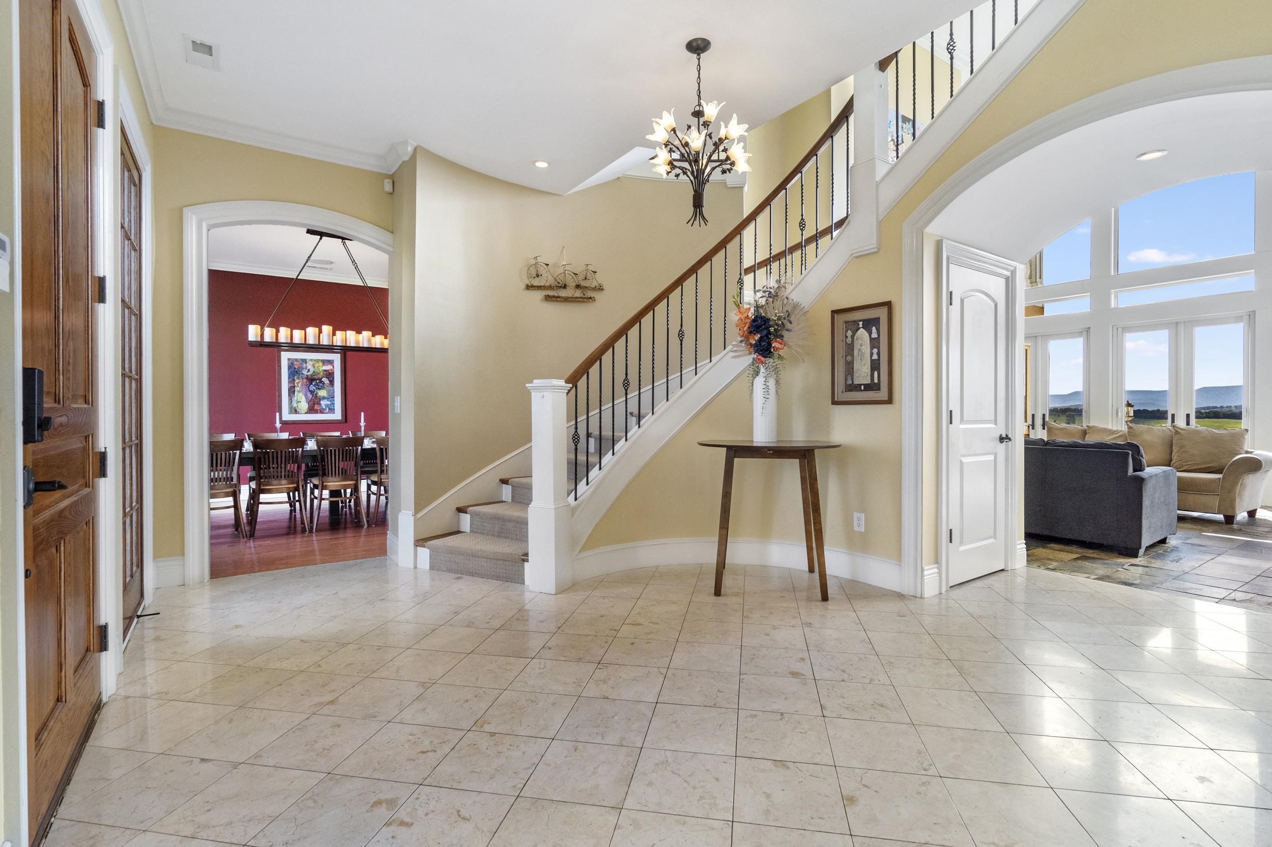 Thought was put into the flooring, the curves, custom curved archways, wide baseboard and crown molding throughout (except laundry room). The staircase gently elevates you to the galley above, overlooking the great room, spectacular views and bedrooms Thought was put into the flooring, the curves, custom curved archways, wide baseboard and crown molding throughout (except laundry room). The staircase gently elevates you to the galley above, overlooking the great room, spectacular views and bedrooms