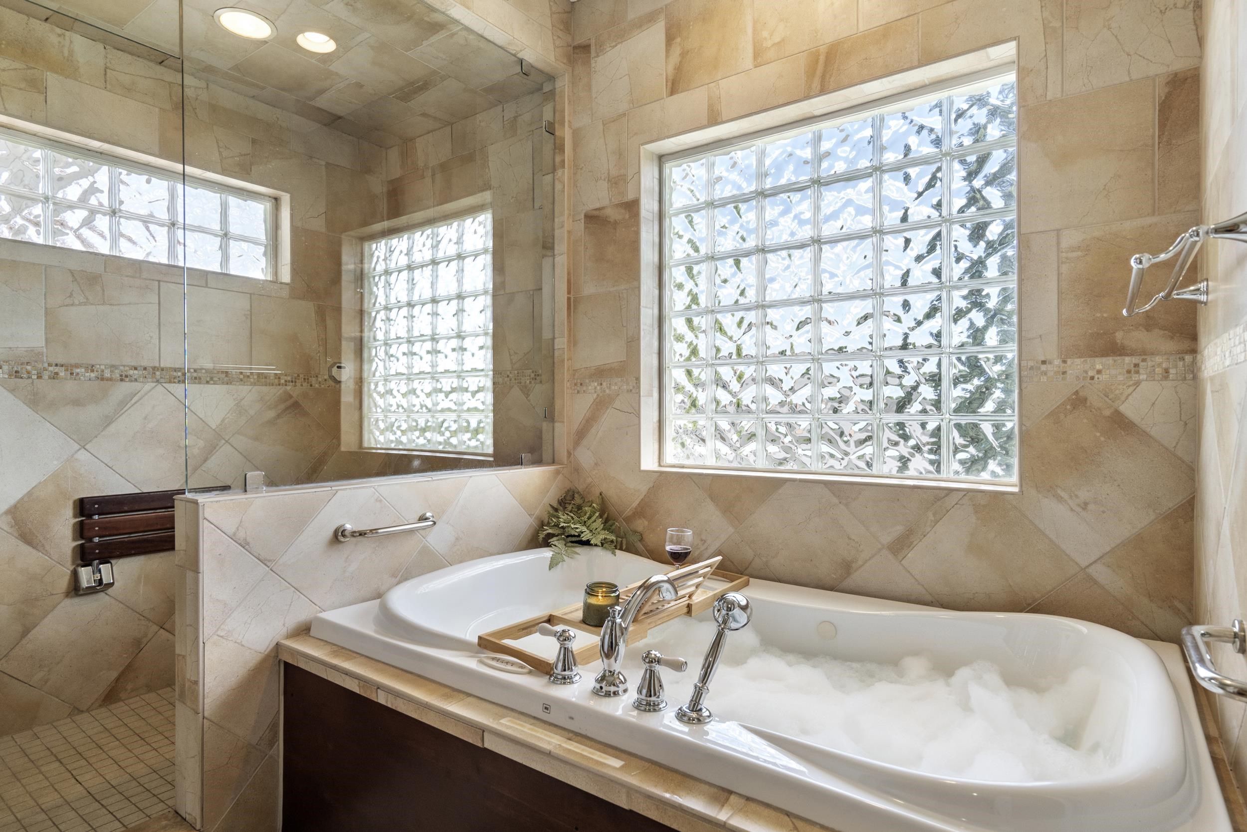 This jetted tub is wisely positioned in the bathroom for the best relaxation. Light a candle, a glass of your favorite dring and read a good book This jetted tub is wisely positioned in the bathroom for the best relaxation. Light a candle, a glass of your favorite dring and read a good book