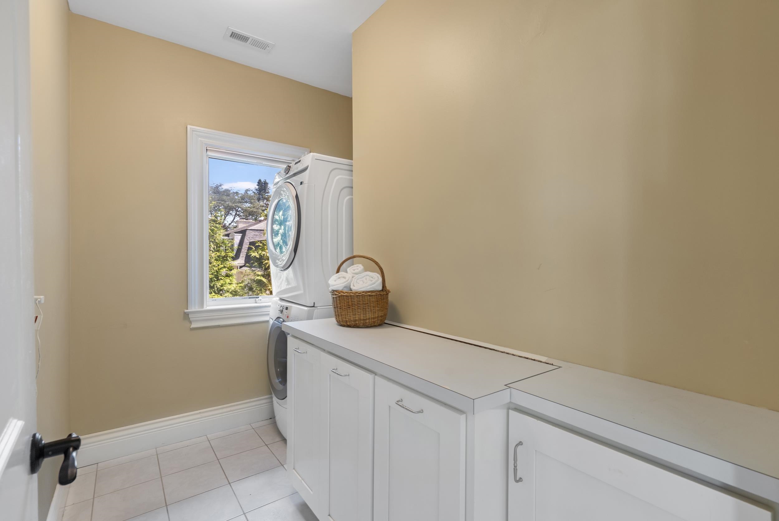 There is storage in the white cabinets, stackable full size front load washer and dryer. Behind the door is a large storage area for linens, ironing items, whatever. There is storage in the white cabinets, stackable full size front load washer and dryer. Behind the door is a large storage area for linens, ironing items, whatever.