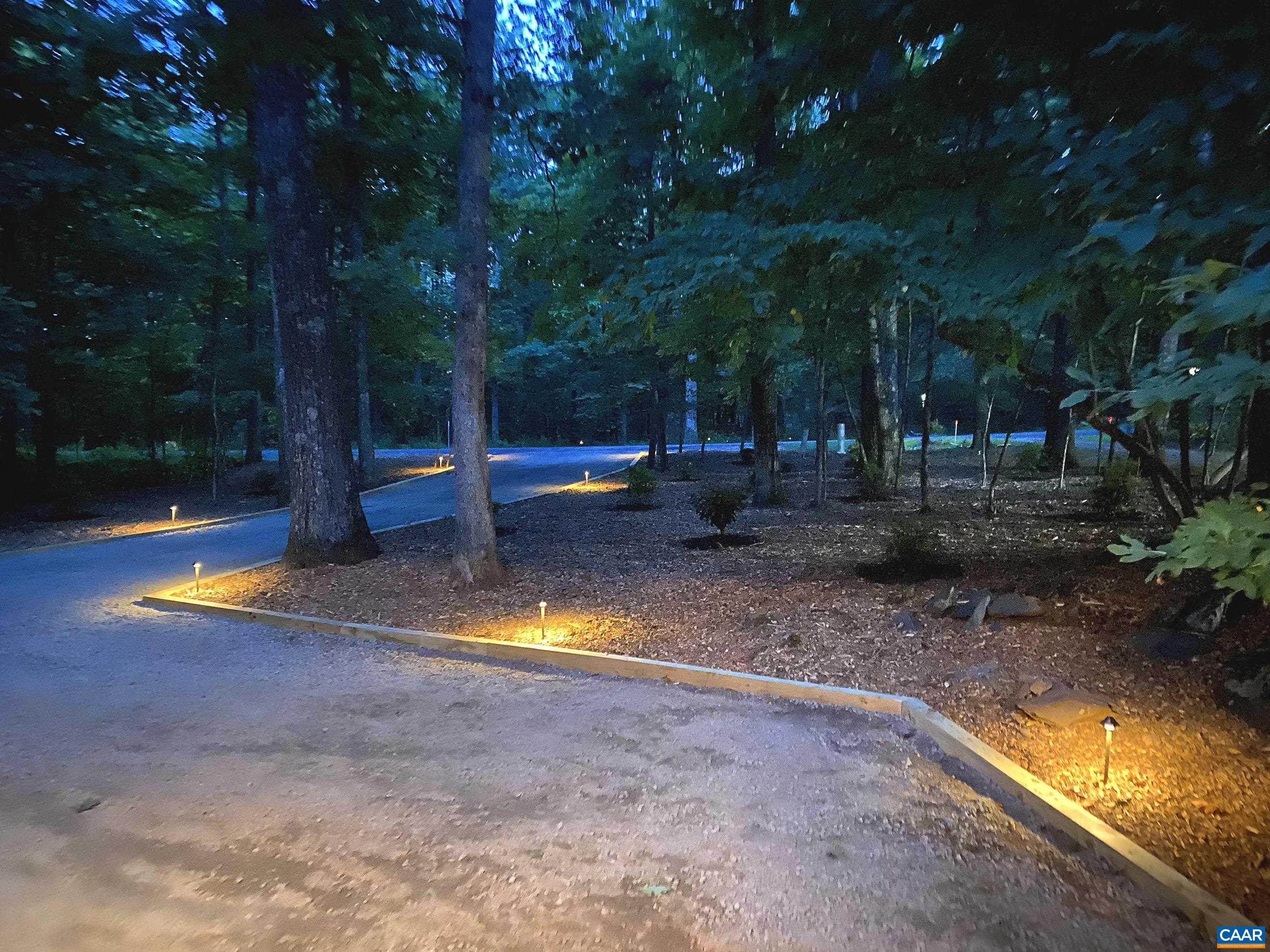 The professionally landscaped front yard features an irrigation system and landscape uplighting, enhancing the home's curb appeal both day and night The professionally landscaped front yard features an irrigation system and landscape uplighting, enhancing the home's curb appeal both day and night