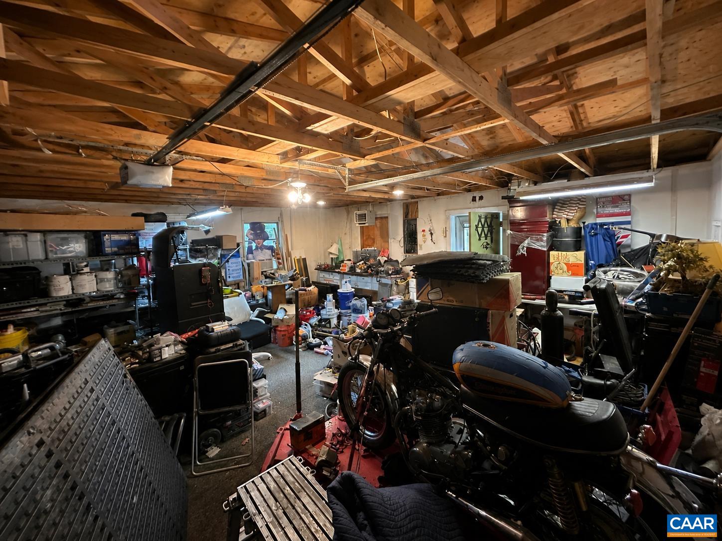 Currently being used as storage. One garage door, other side of building is workshop area.