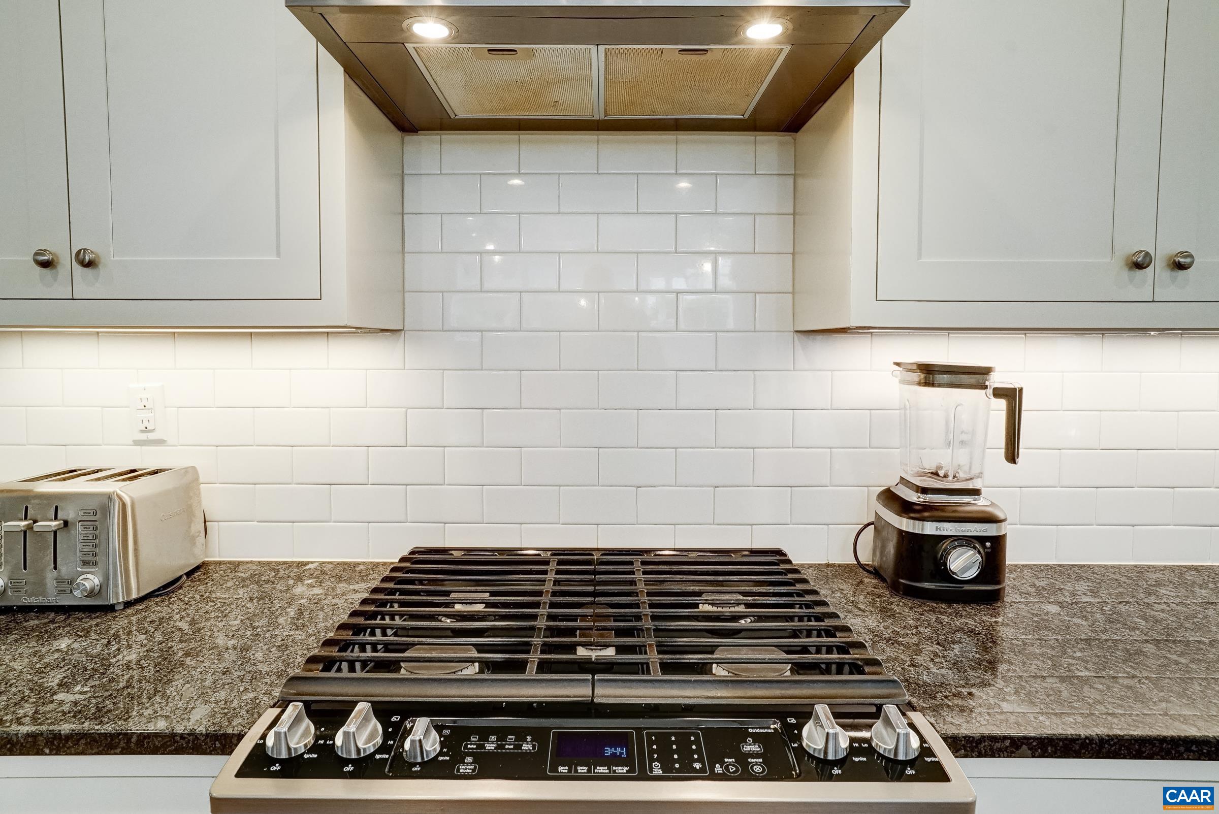 Gas range with stainless hood. Gas range with stainless hood.