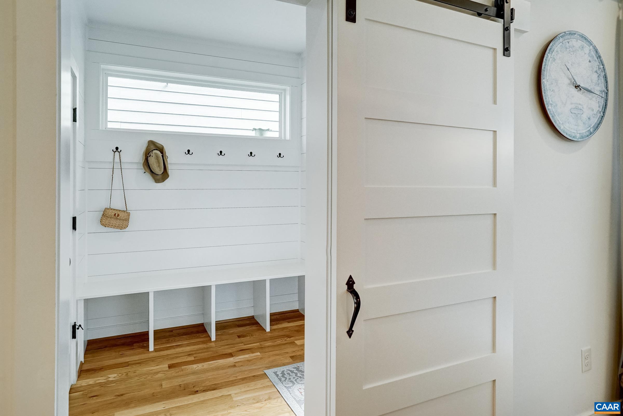 Sliding barn door leads to custom mudroom. Sliding barn door leads to custom mudroom.