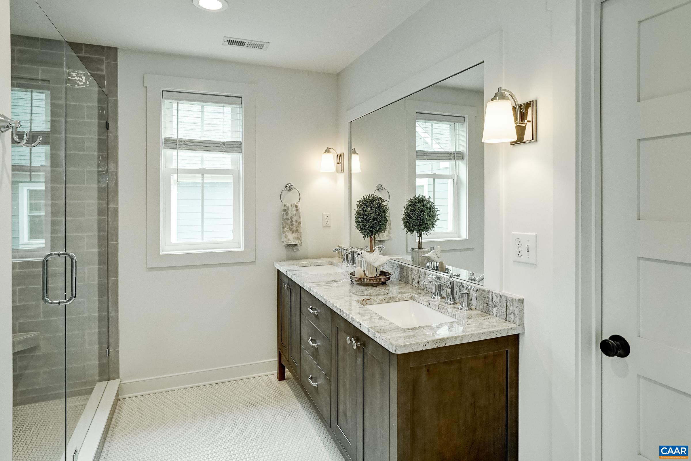 Primary bathroom features double sink vanity and walk in shower. Primary bathroom features double sink vanity and walk in shower.
