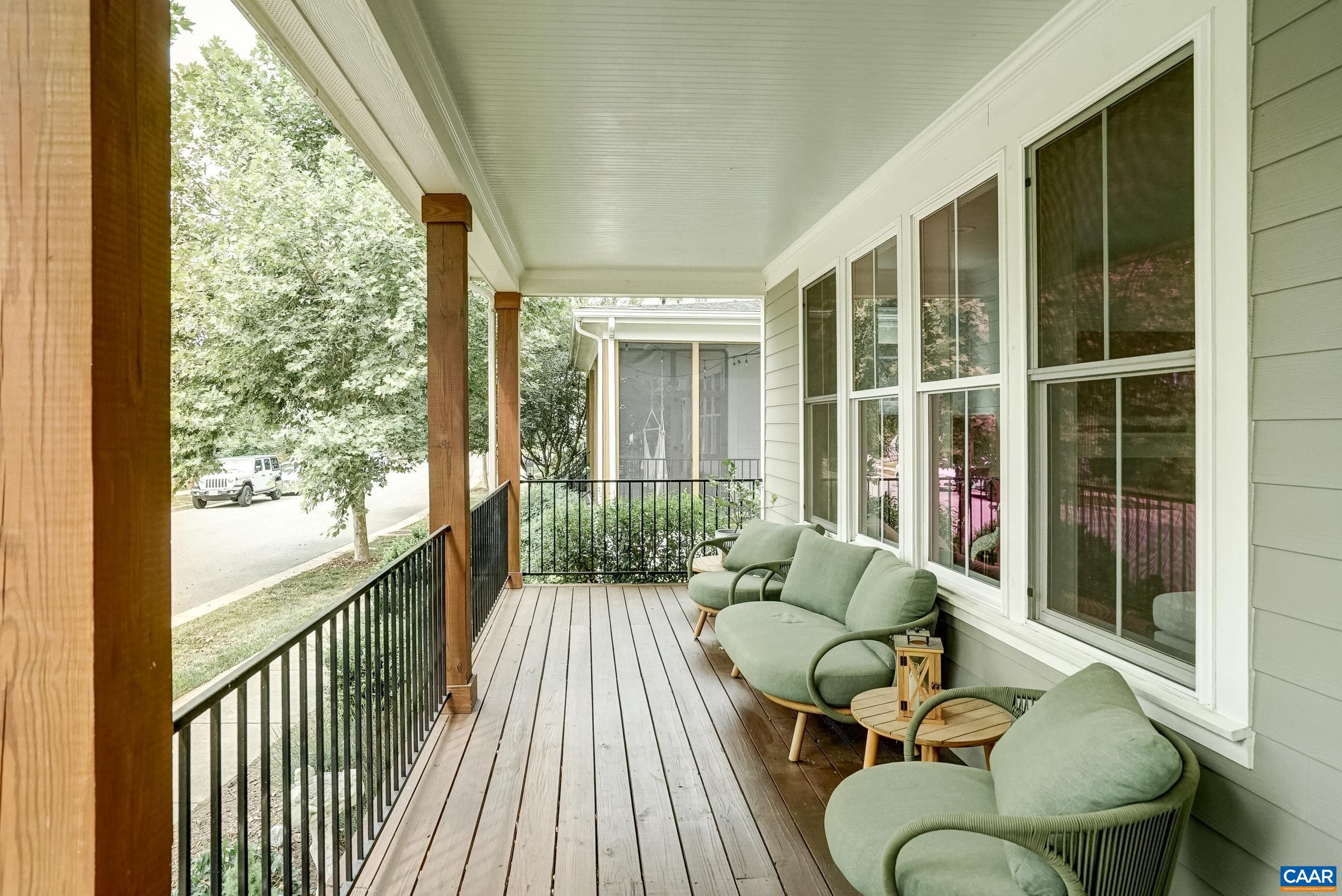 Welcoming covered front porch with beadboard ceiling overlooks shady street with mature trees. Welcoming covered front porch with beadboard ceiling overlooks shady street with mature trees.