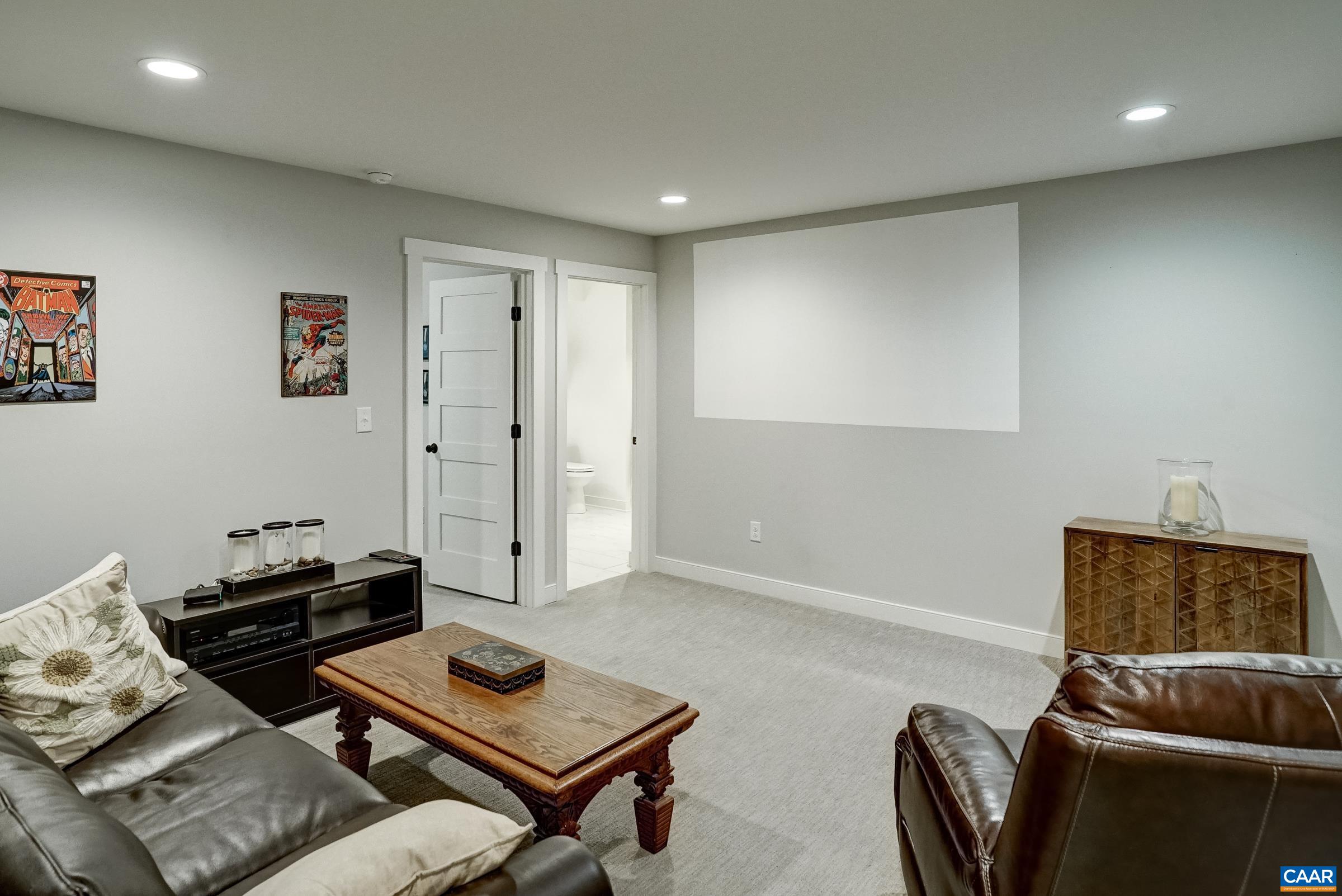 Finished basement features a rec room wtih projector and screen area. Finished basement features a rec room wtih projector and screen area.